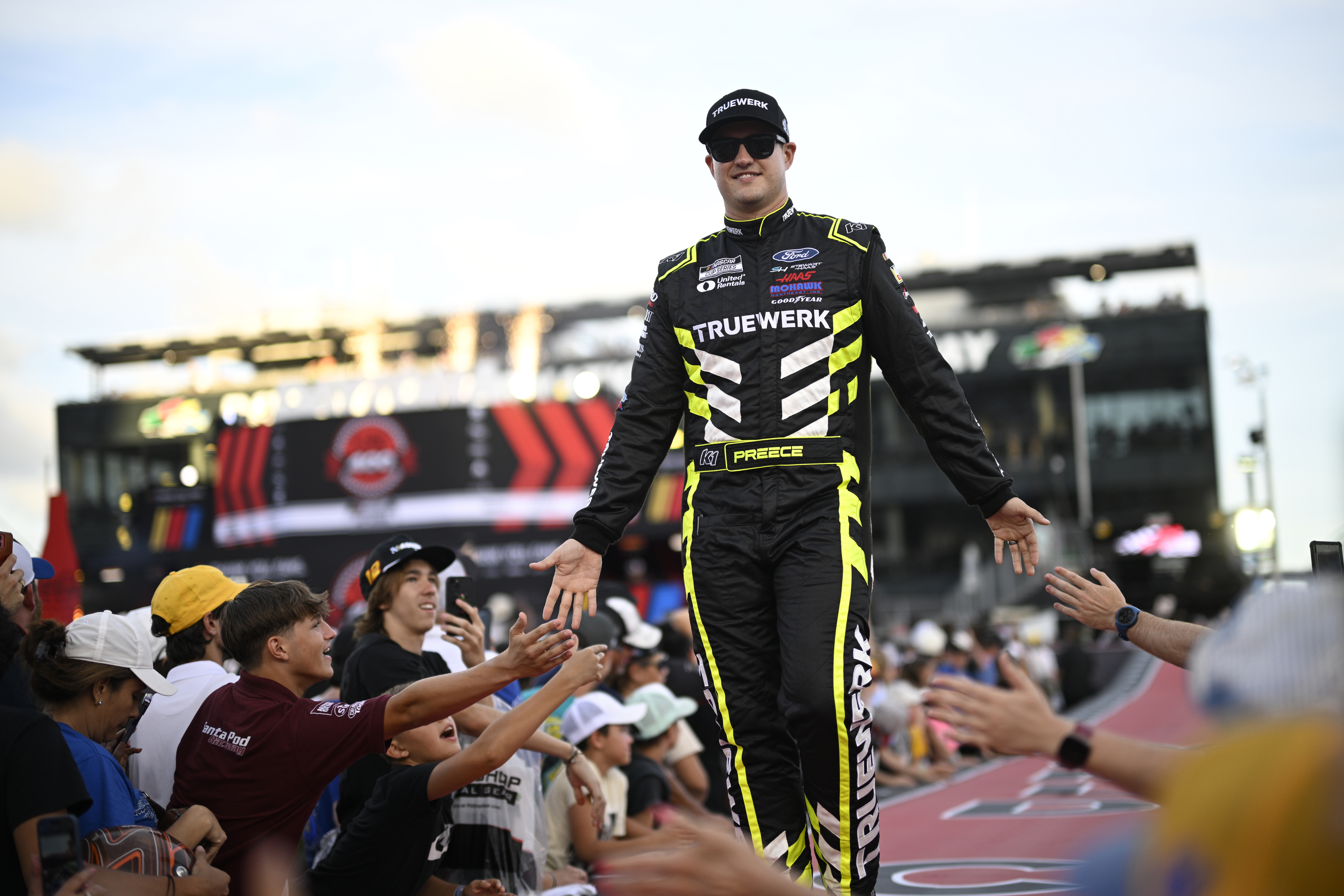 FILE - Ryan Preece interacts with spectators while walking down a runway during driver introductions before a NASCAR Cup Series auto race at Daytona International Speedway, Saturday, Aug. 24, 2024, in Daytona Beach, Fla.