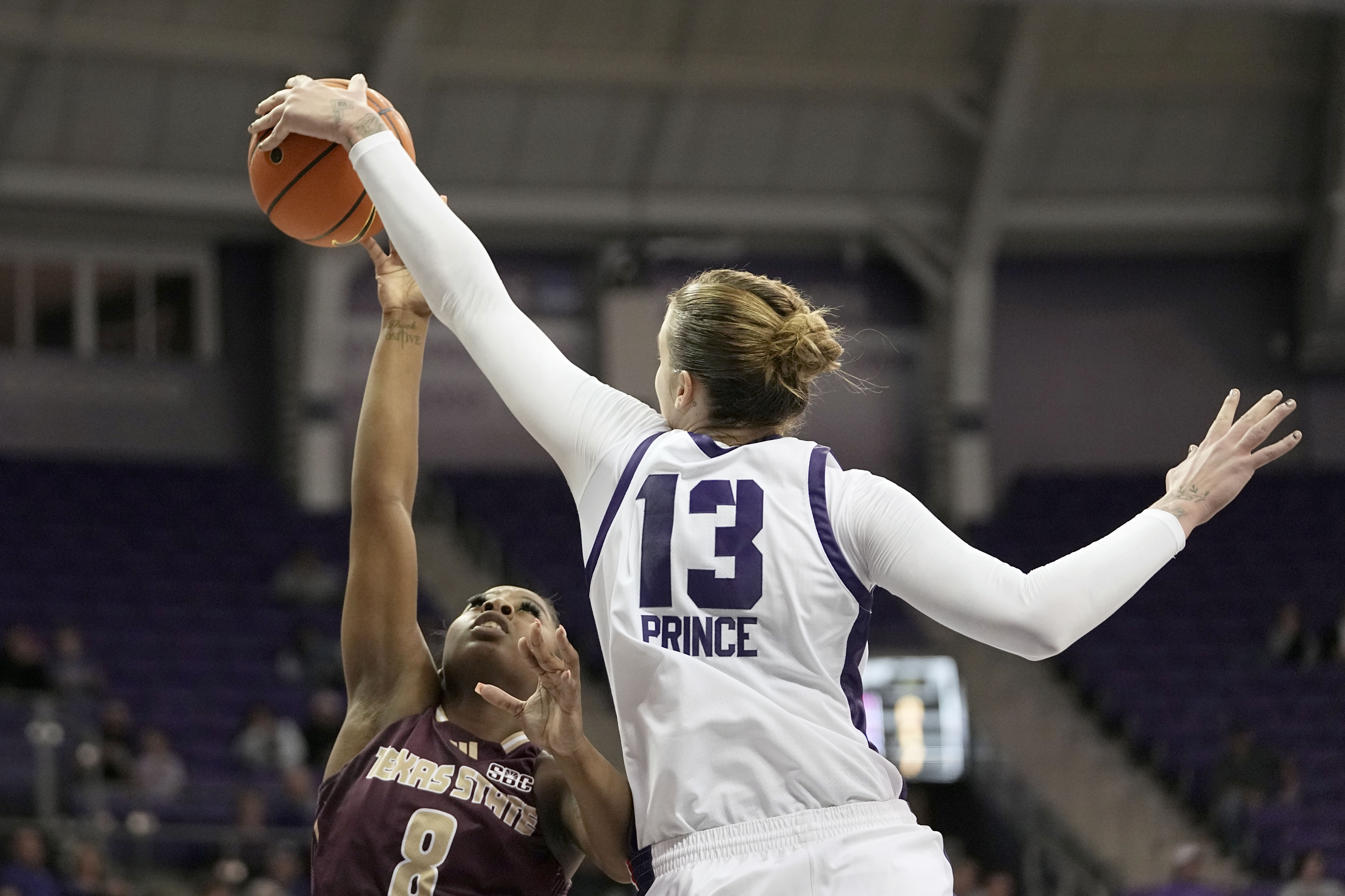 Texas State guard Ja'Mia Harris (8) has her shot blocked by TCU center Sedona Prince (13) in the first half of an NCAA college basketball game in Fort Worth, Texas, Wednesday, Nov. 13, 2024.