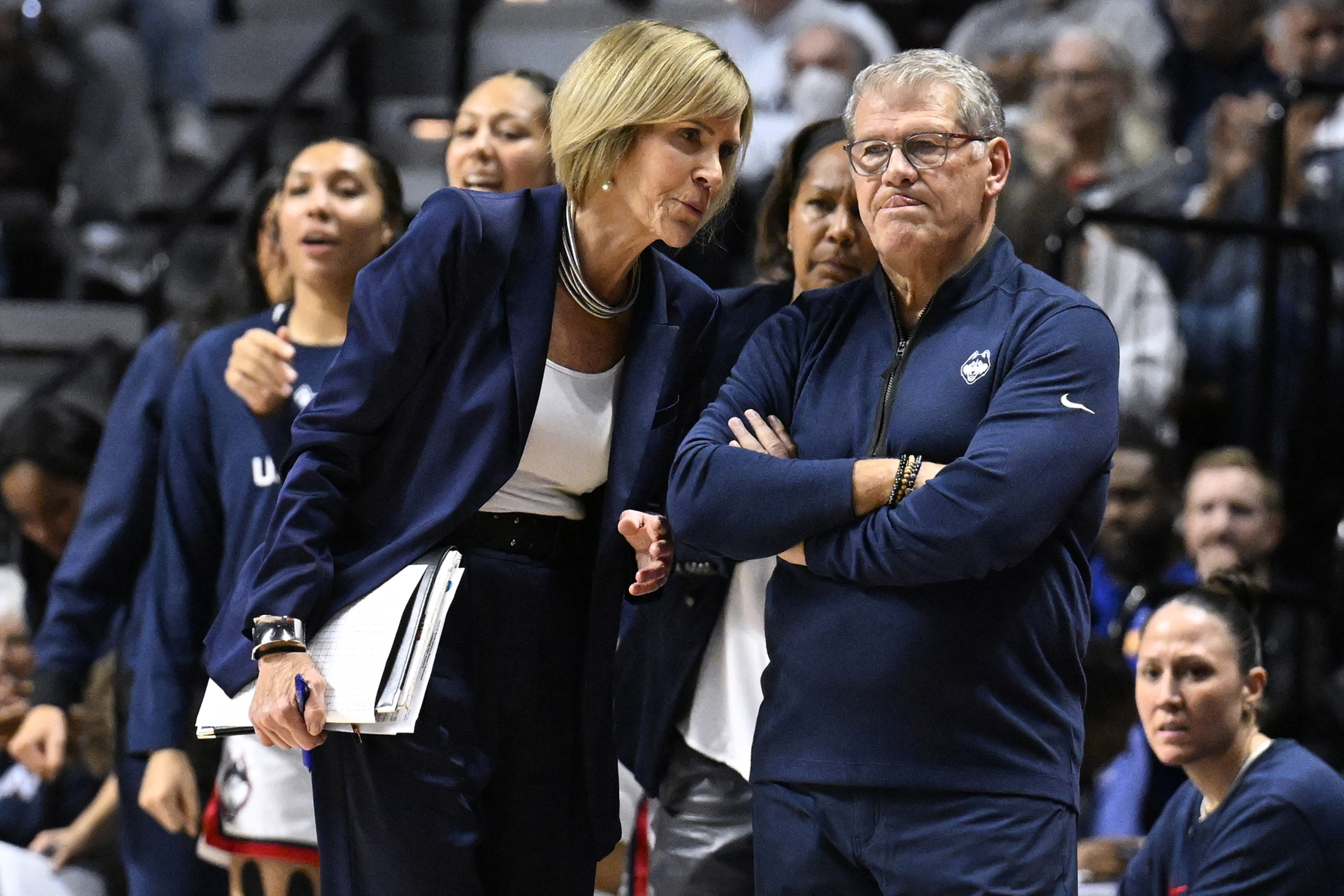 FILE - UConn associate head coach Chris Dailey speaks with UConn head coach Geno Auriemma during the first half of an NCAA college basketball game against North Carolina, Sunday, Dec. 10, 2023, in Uncasville, Conn. 