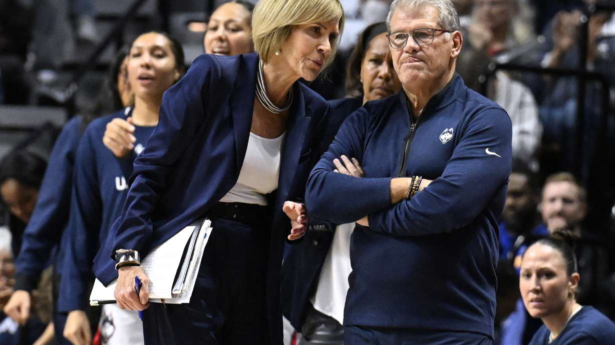 FILE - UConn associate head coach Chris Dailey speaks with UConn head coach Geno Auriemma during the first half of an NCAA college basketball game against North Carolina, Sunday, Dec. 10, 2023, in Uncasville, Conn.