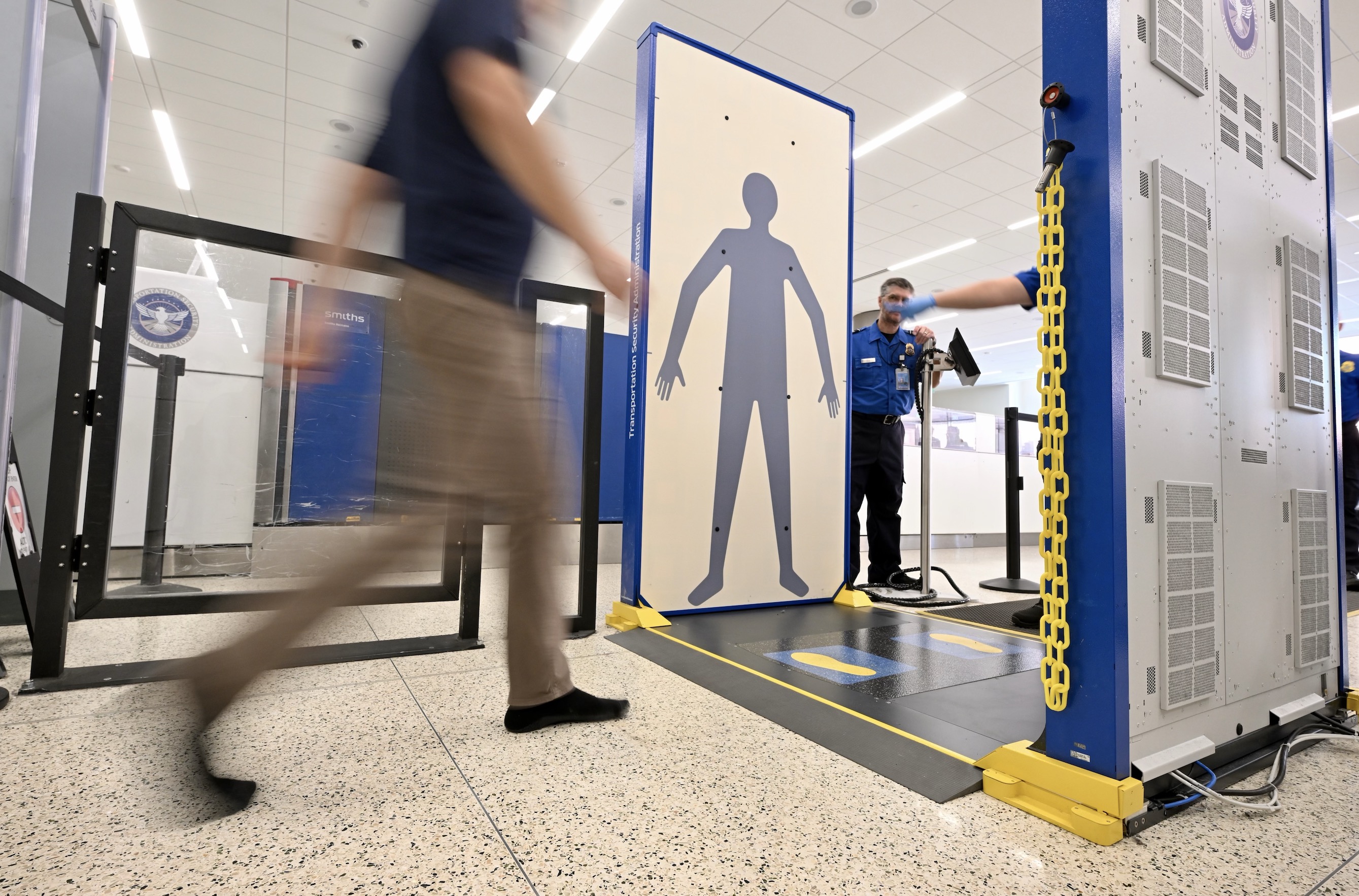 Passengers walk through a new TSA screening system at Salt Lake International Airport on Tuesday.