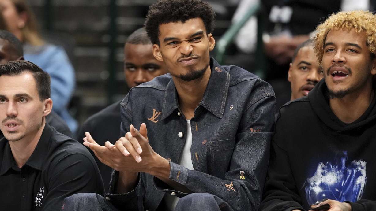 San Antonio Spurs center Victor Wembanyama, who is out with a knee contusion, reacts to a play during the second half of an NBA basketball game Saturday, Nov. 16, 2024, in Dallas. Dallas won 110-93.