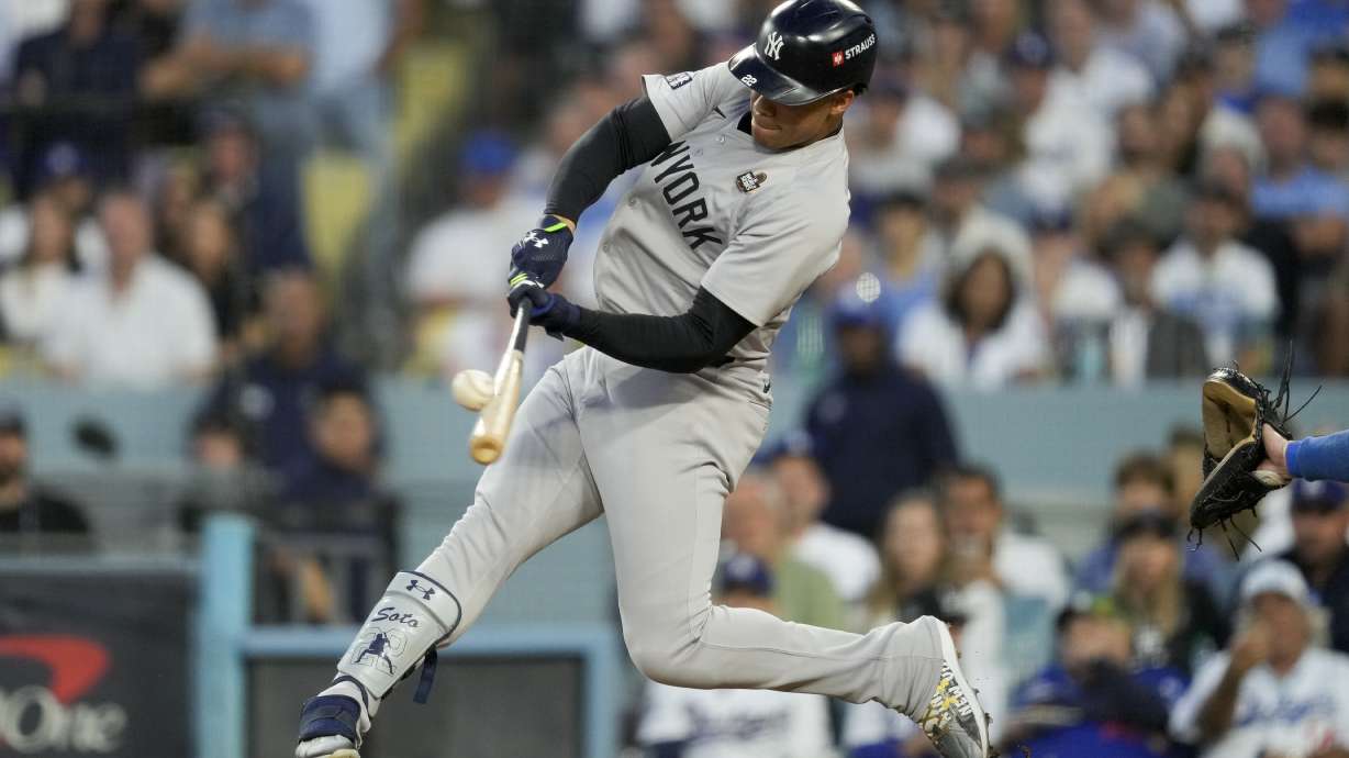 New York Yankees' Juan Soto hits a home run against the Los Angeles Dodgers during the third inning in Game 2 of the baseball World Series, Saturday, Oct. 26, 2024, in Los Angeles.