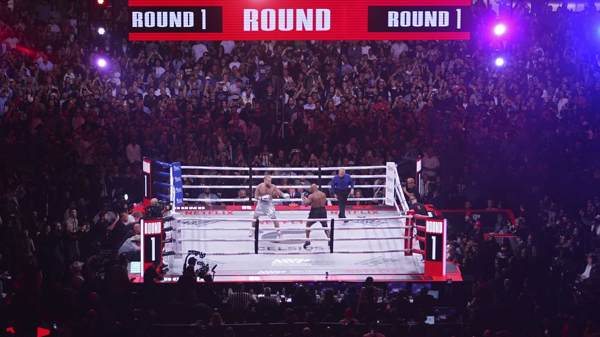Jake Paul, left, and Mike Tyson fight during their heavyweight boxing match, Friday, Nov. 15, 2024, in Arlington, Texas.