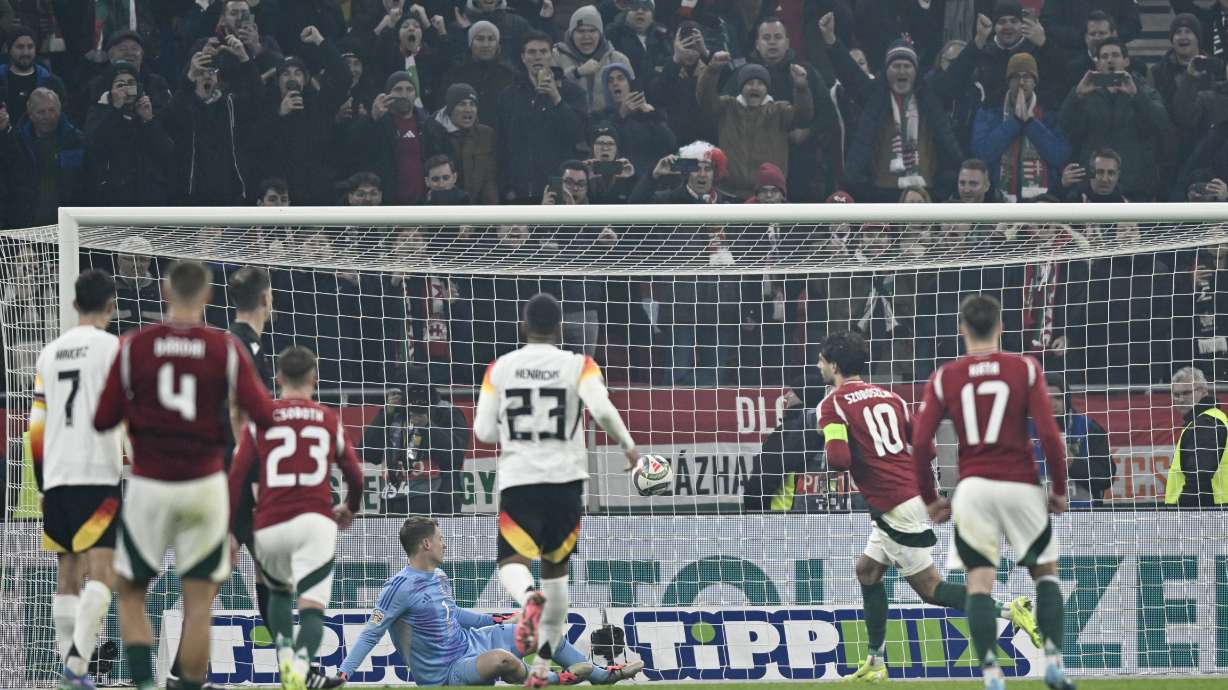 Hungary's Dominik Szoboszlai scores his side's first goal from the penalty spot during the Nations League soccer match between Hungary and Germany at the Puskas Arena stadium in Budapest, Tuesday, Nov. 18, 2024.