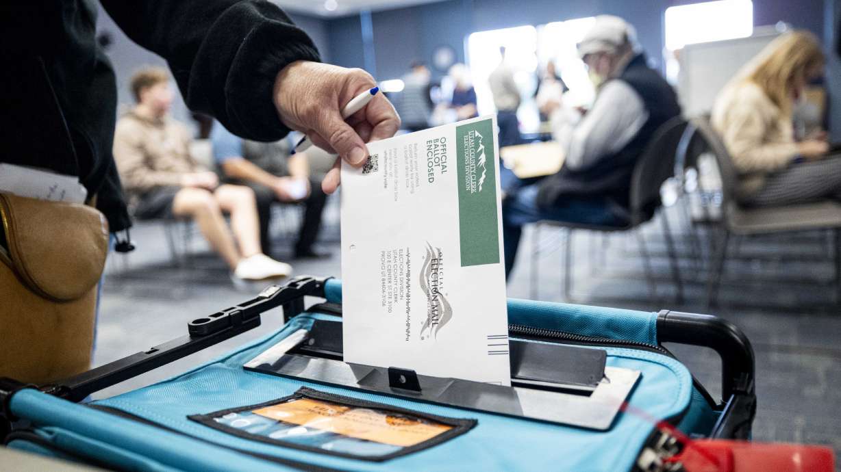 A voter drops a ballot in Provo on Oct. 30. A Utah judge on Tuesday temporarily blocked the certification of a Wasatch County school board race after a candidate sued the county clerk over his disqualification.
