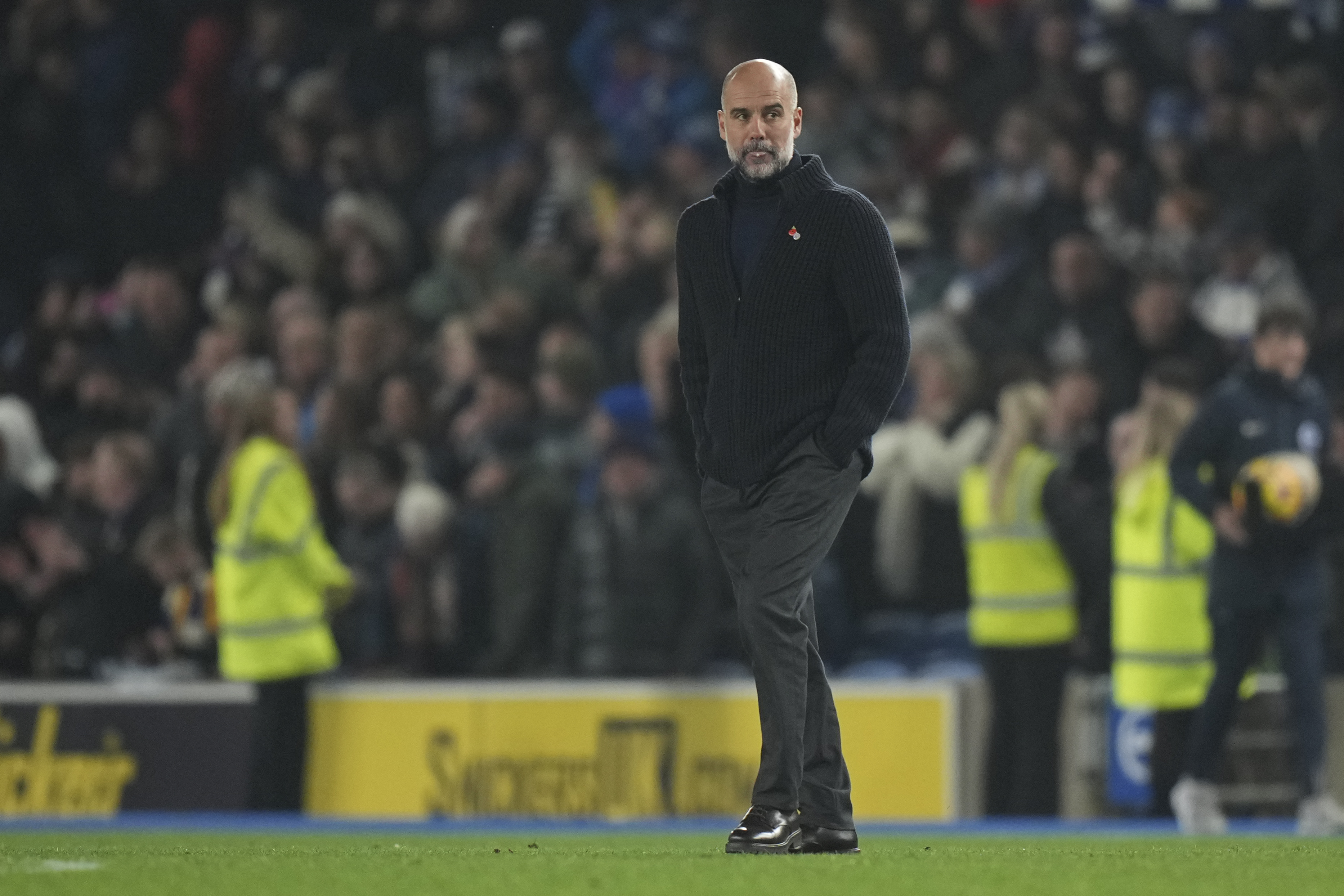 Manchester City's head coach Pep Guardiola leaves the pitch after the English Premier League soccer match between Brighton and Manchester City at Falmer Stadium in Brighton, England, Saturday, Nov. 9, 2024.