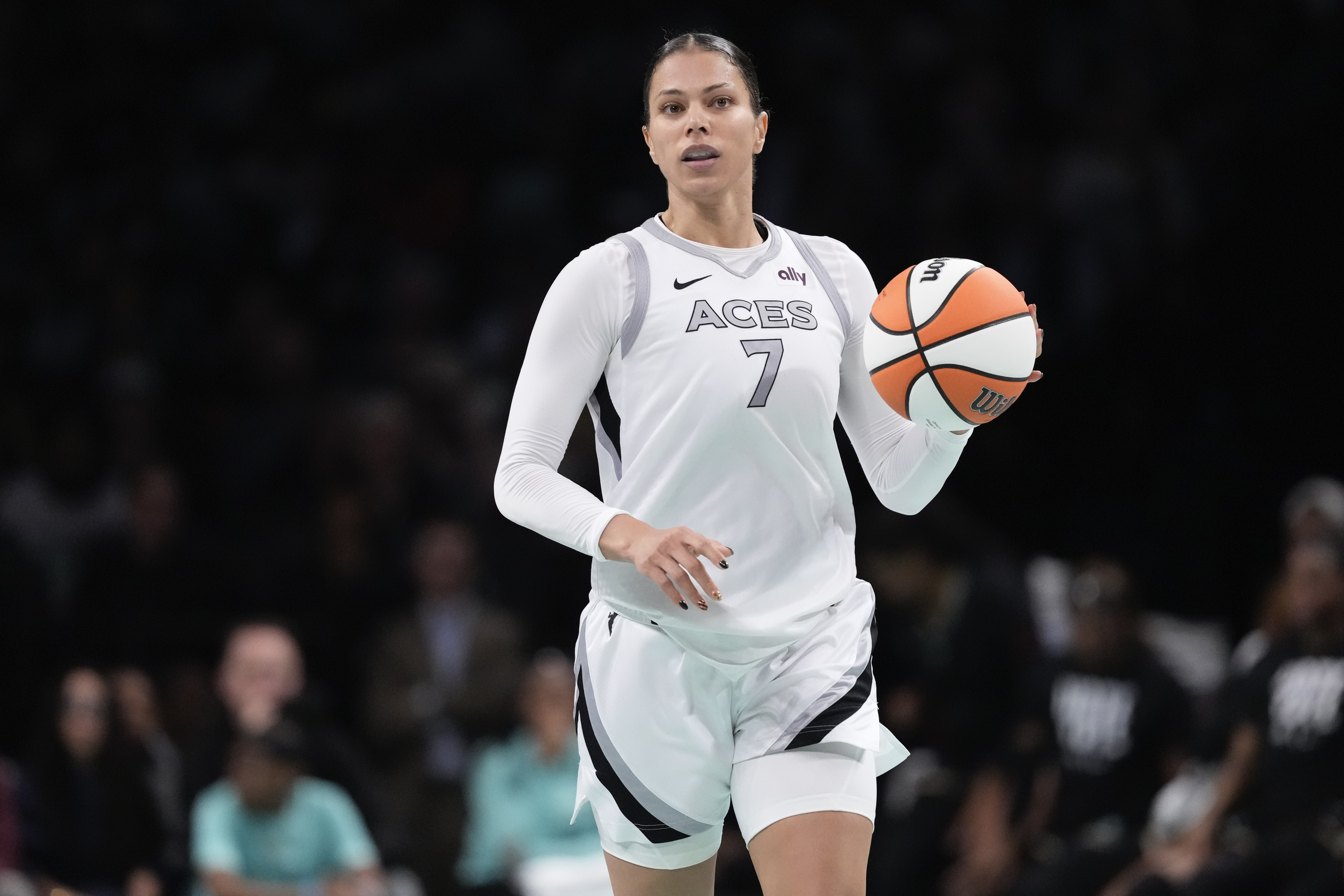 FILE - Las Vegas Aces' Alysha Clark (7) looks to pass during the second half of a WNBA basketball semifinal game against the New York Liberty, Oct. 1, 2024, in New York. 