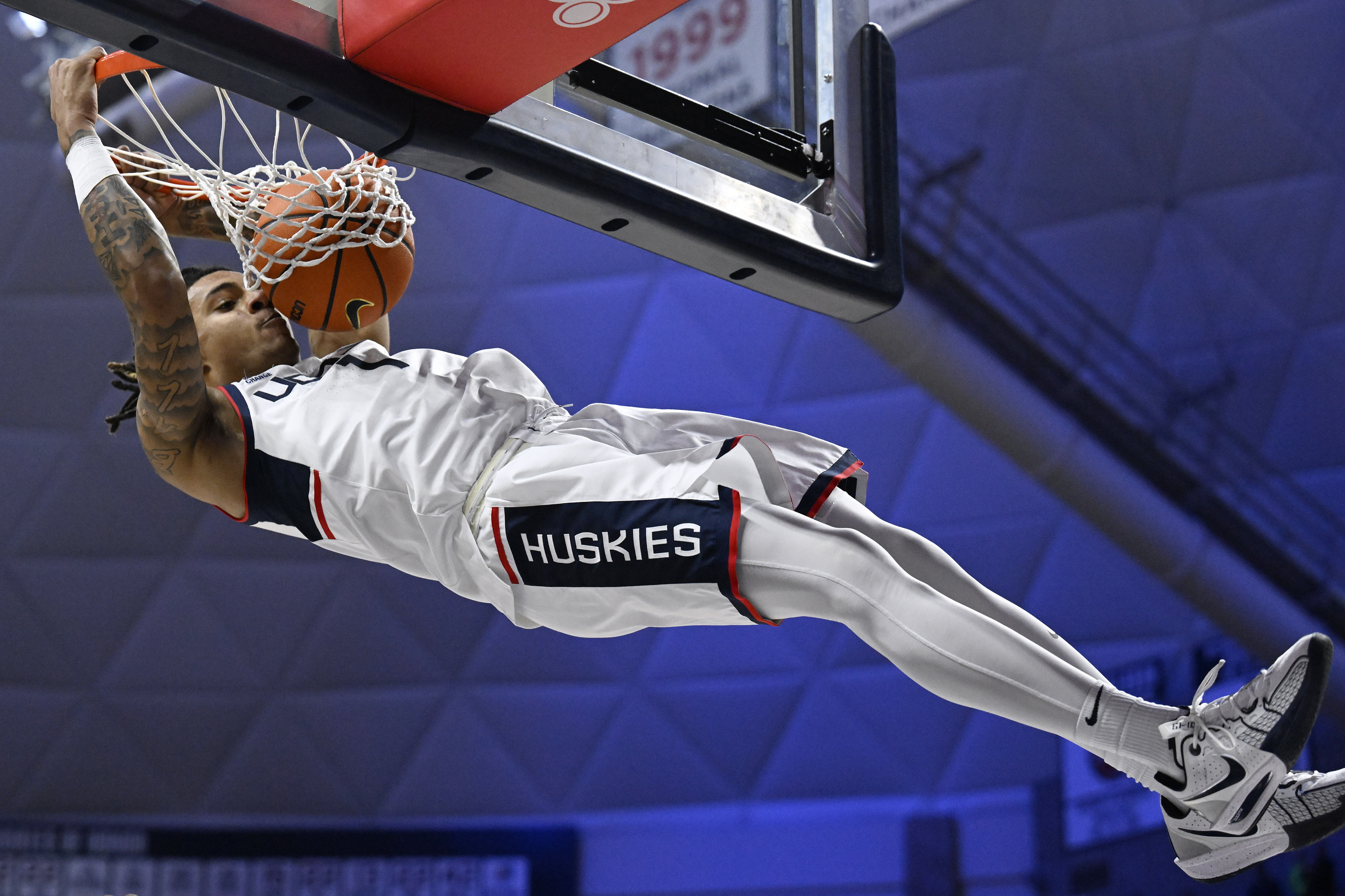 UConn guard Solo Ball (1) dunks the ball in the first half of an NCAA college basketball game against East Texas A&M, Tuesday, Nov. 19, 2024, in Storrs, Conn.