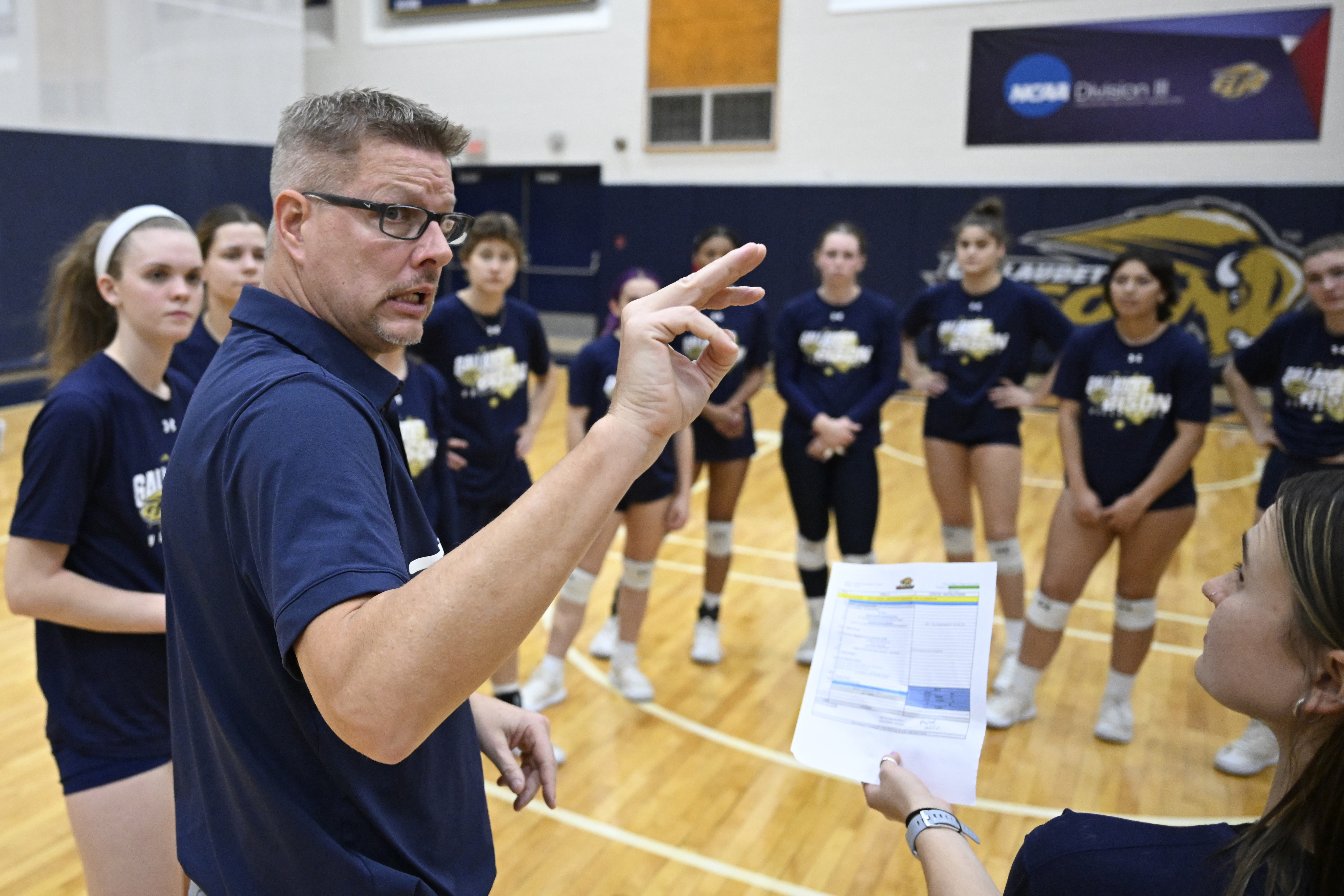 Gallaudet women's volleyball head coach Lynn Ray Boren uses American Sign Language to communicate with his team while their team prepares for the upcoming Division III NCAA Tournament, during a practice Monday, Nov. 18, 2024, in Washington. 