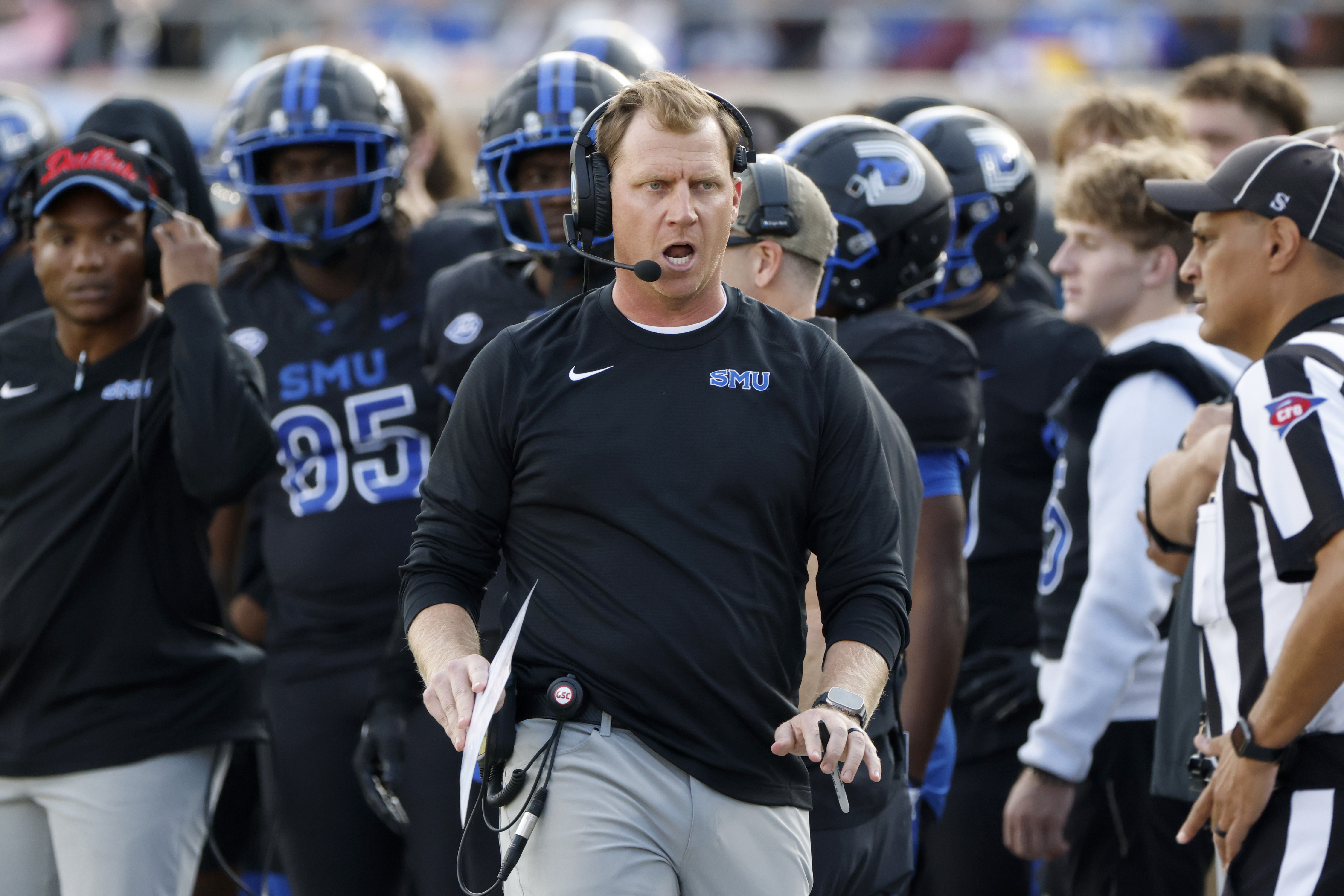 SMU head football coach Rhett Lashlee, center, argues a call during the first half of an NCAA college football game against Boston College, in University Park, Texas, Saturday, Nov. 16, 2024. 