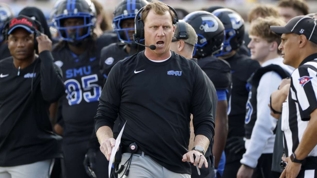 SMU head football coach Rhett Lashlee, center, argues a call during the first half of an NCAA college football game against Boston College, in University Park, Texas, Saturday, Nov. 16, 2024.