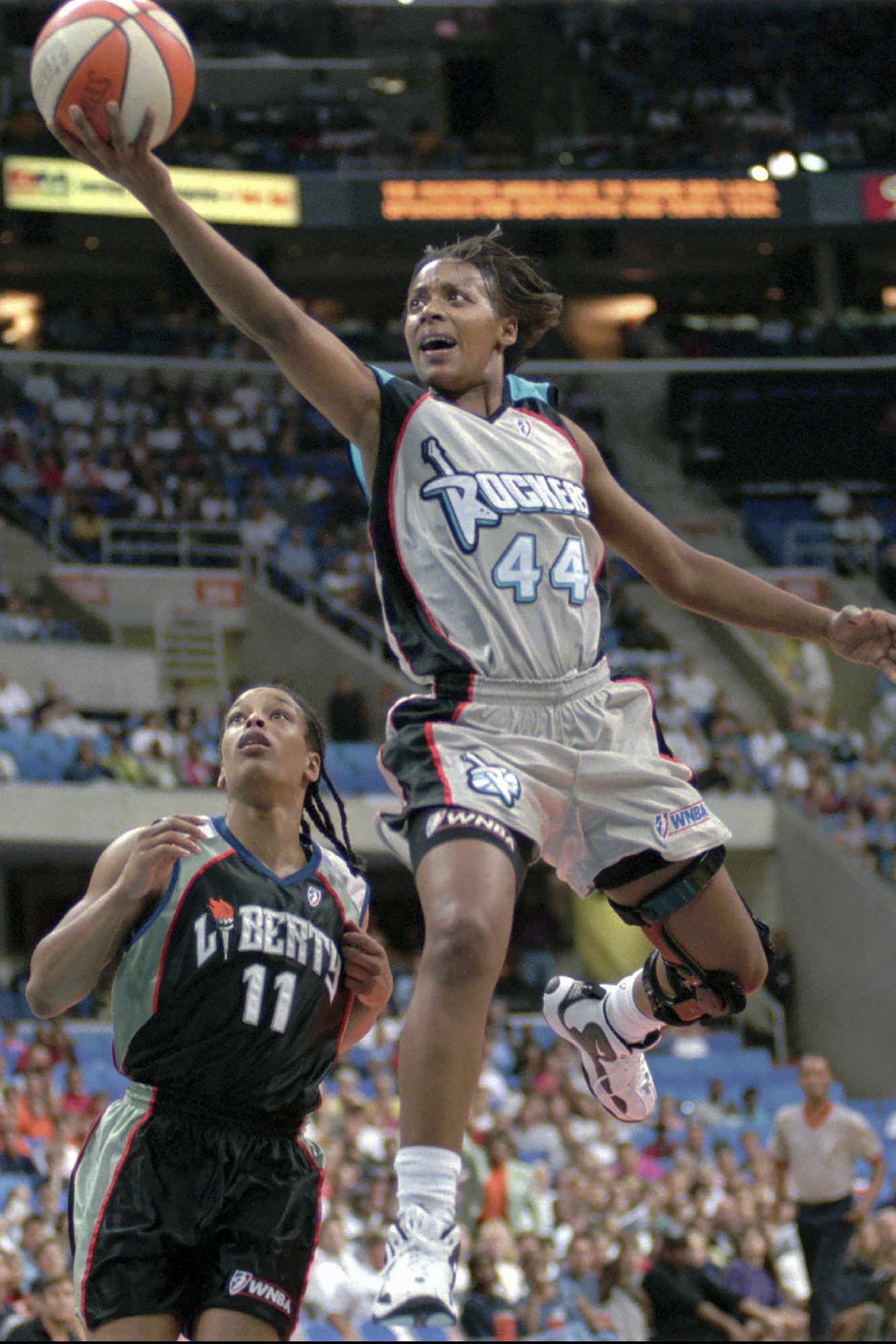 FILE - Cleveland Rockers' Michelle Edwards goes to the basket past New York Liberty's Theresa Weatherspoon, left, at Gund Arena in Cleveland, Aug. 23, 1997.
