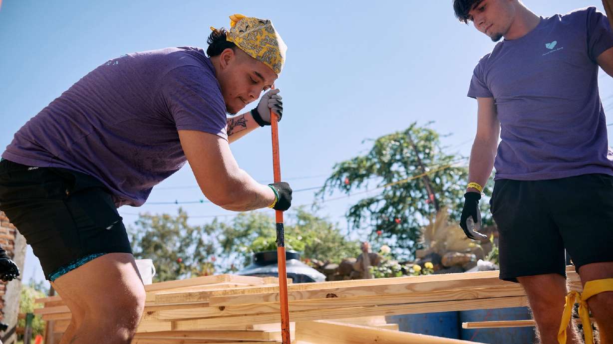 Two of the volunteers from Provo-based Vivint who assisted in a charitable home-building initiative in Guadalajara, Mexico, at work on Oct. 10.