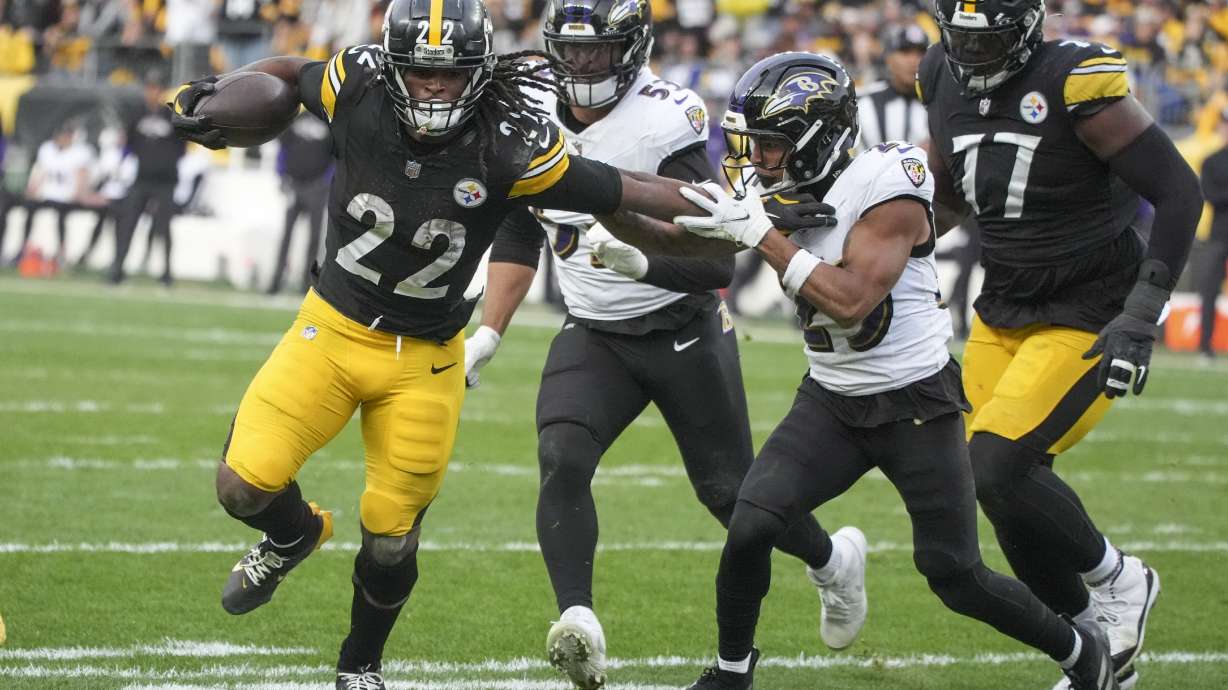 Pittsburgh Steelers running back Najee Harris (22) applies a stiff arm on Baltimore Ravens safety Ar'Darius Washington (29) during the second half of an NFL football game, Sunday, Nov. 17, 2024, in Pittsburgh.