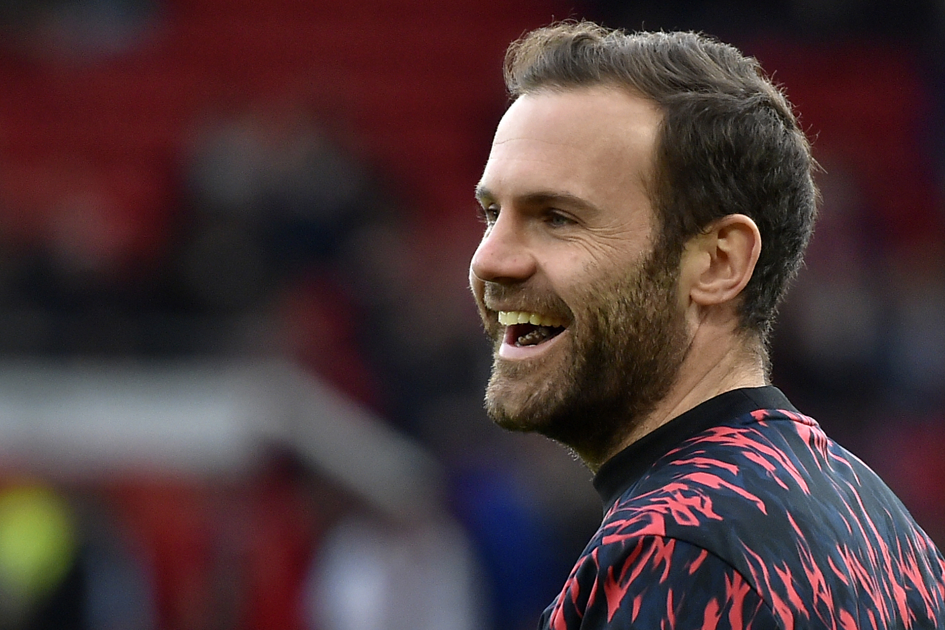 FILE - Manchester United's Juan Mata smiles during the warm up before the English Premier League soccer match between Manchester United and Tottenham Hotspur, at the Old Trafford stadium in Manchester, England, March 12, 2022.
