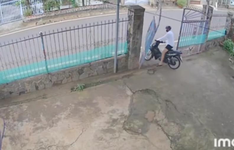 A motorist rides right through a gate on Nov. 15 in Dong Nai, Vietnam.