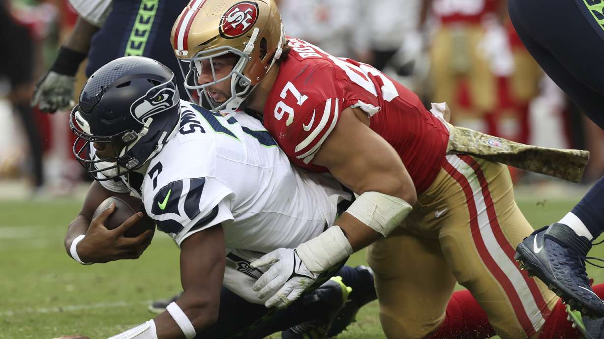 San Francisco 49ers defensive end Nick Bosa (97) sacks Seattle Seahawks quarterback Geno Smith during the second half of an NFL football game in Santa Clara, Calif., Sunday, Nov. 17, 2024.