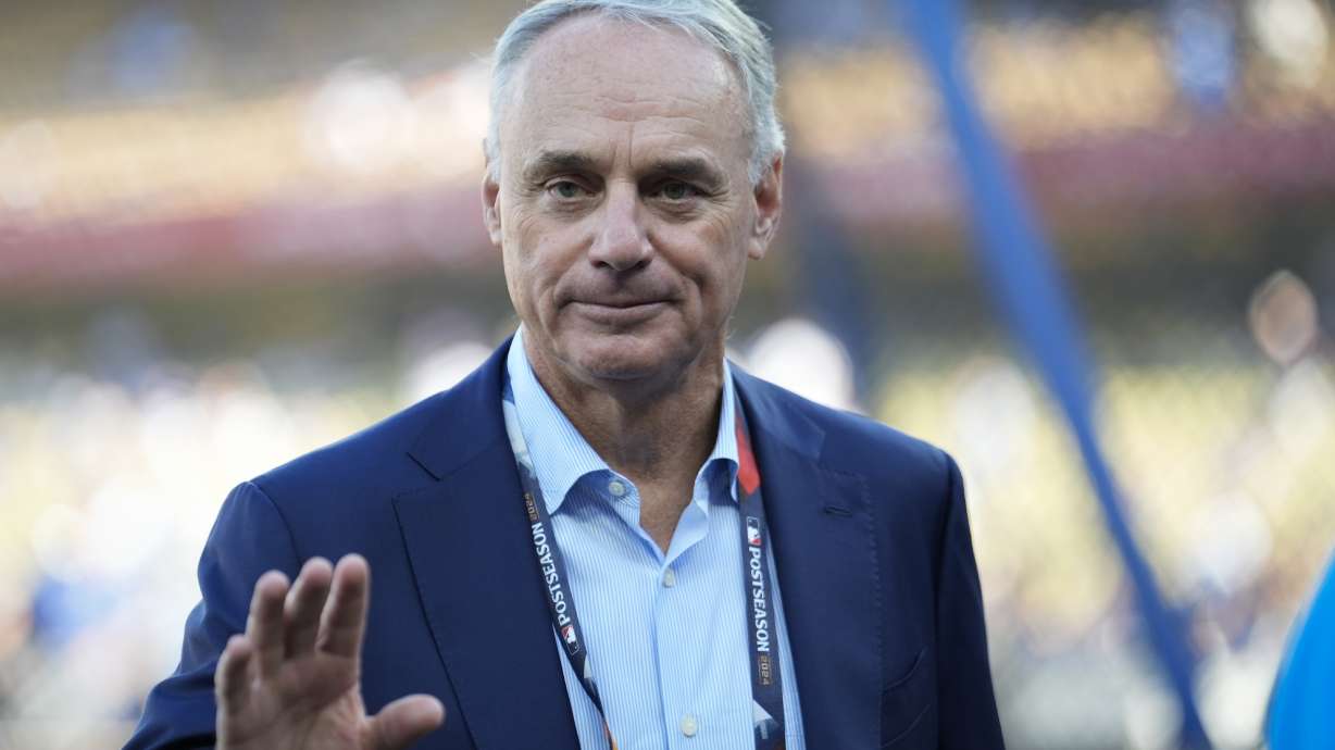 Commissioner of Major League Baseball, Rob Manfred walks on the field before Game 2 of the baseball World Series between the Los Angeles Dodgers and the New York Yankees, Saturday, Oct. 26, 2024, in Los Angeles.