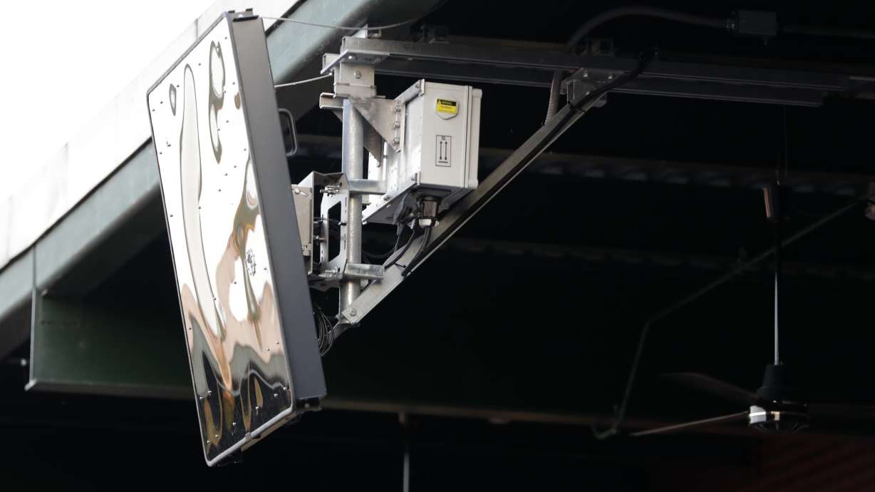 FILE -A radar device is seen on the roof behind home plate at PeoplesBank Park during the third inning of the Atlantic League All-Star minor league baseball game, Wednesday, July 10, 2019, in York, Pa. Major League Baseball will test robot umpires as part of a challenge system during spring training at 13 ballparks hosting 19 teams, which could lead to regular-season use in 2026.