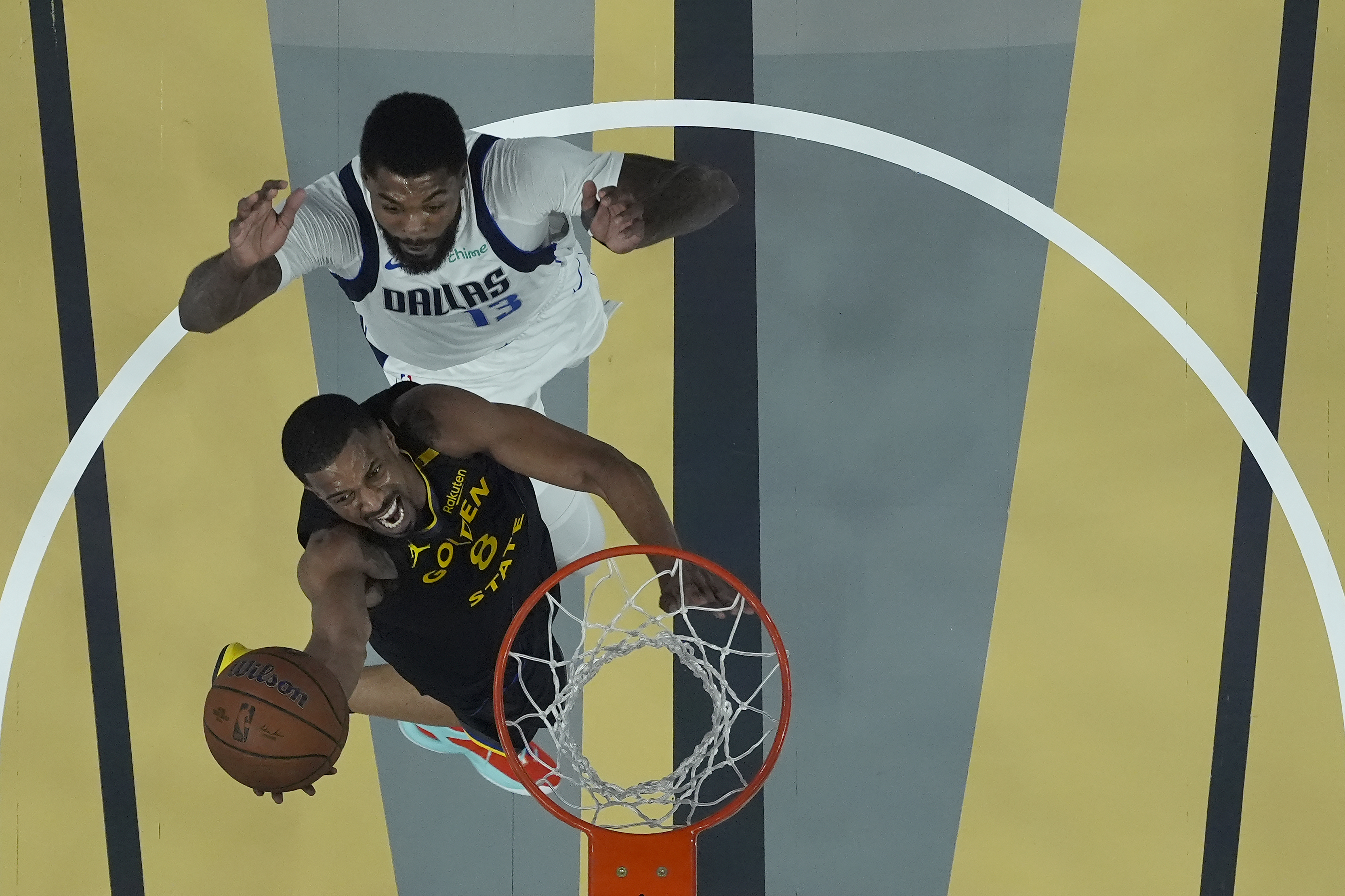 Golden State Warriors guard De'Anthony Melton, bottom, shoots against Dallas Mavericks forward Naji Marshall (13) during the first half of an Emirates NBA Cup basketball game in San Francisco, Tuesday, Nov. 12, 2024.