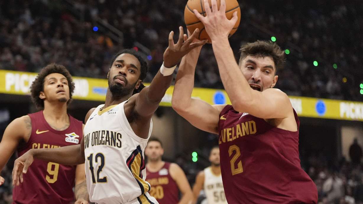 Cleveland Cavaliers guard Ty Jerome (2) takes the ball from New Orleans Pelicans guard Antonio Reeves (12) in the first half of an NBA basketball game, Wednesday, Nov. 20, 2024, in Cleveland.