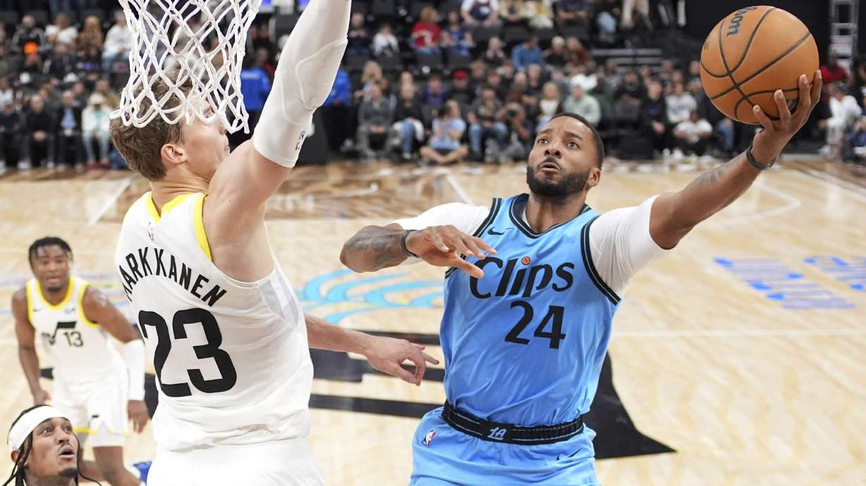 Los Angeles Clippers guard Norman Powell, right, shoots as Utah Jazz forward Lauri Markkanen defends during the second half of an NBA basketball game, Sunday, Nov. 17, 2024, in Inglewood, Calif.