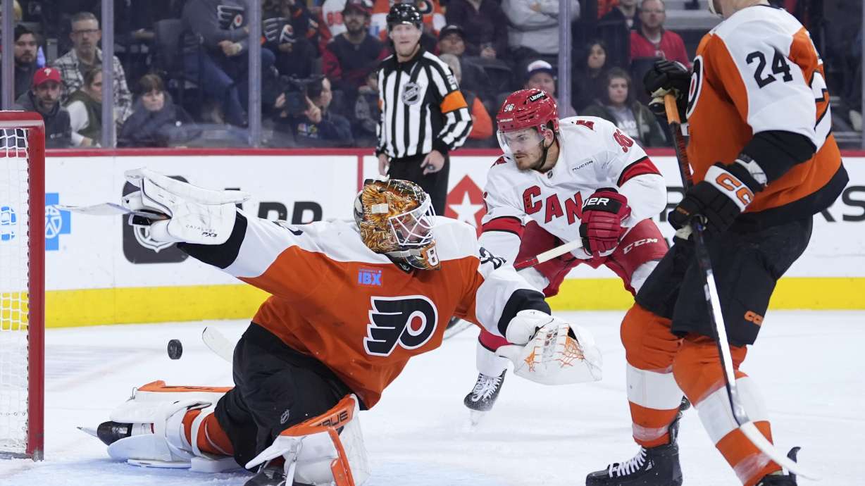 Carolina Hurricanes' Jack Roslovic, center, scores a goal against Philadelphia Flyers' Ivan Fedotov during the third period of an NHL hockey game, Wednesday, Nov. 20, 2024, in Philadelphia.