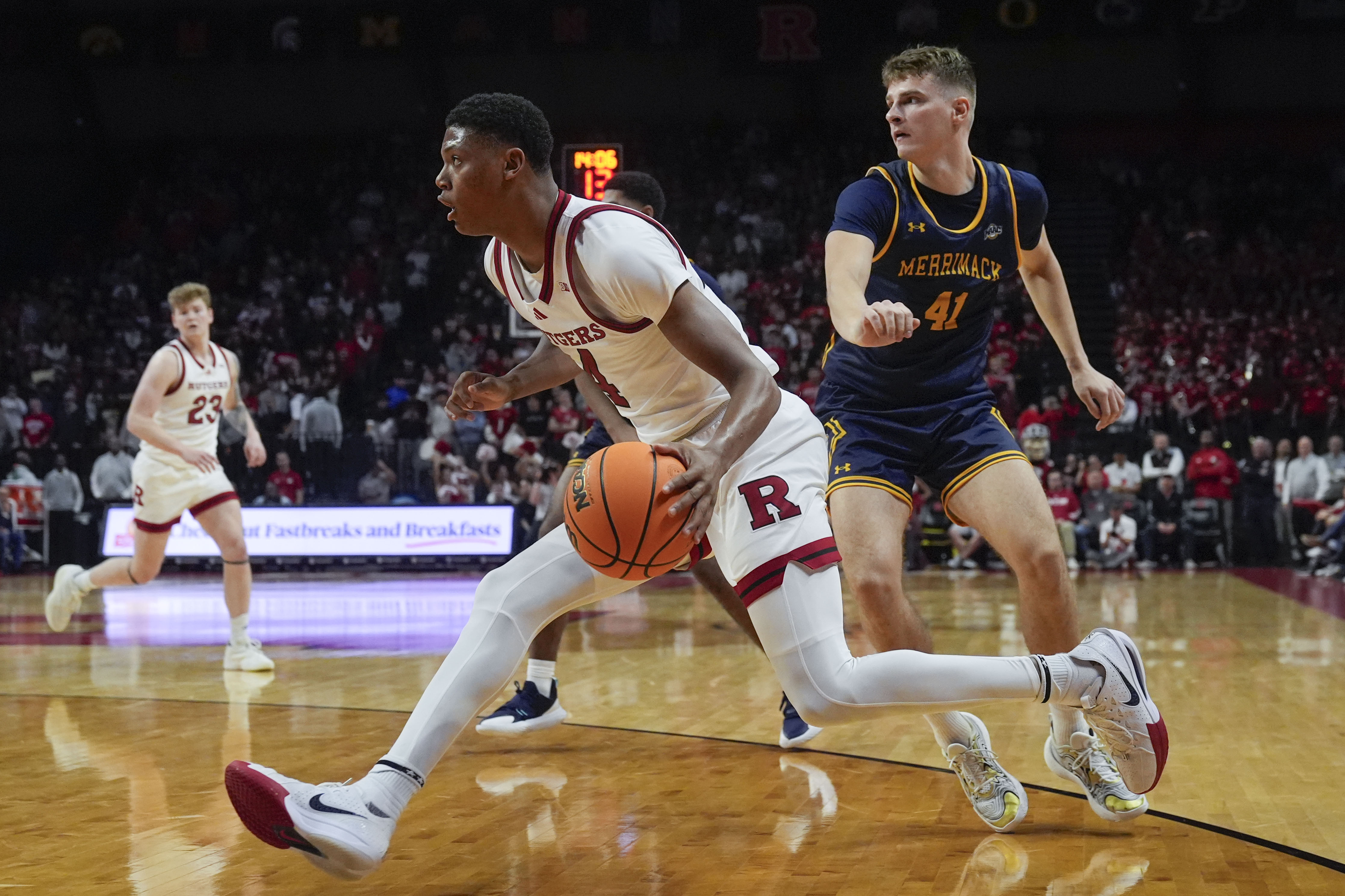 Rutgers' Ace Bailey, center, drives past Merrimack's Armandas Plintauskas (41) during the second half of an NCAA college basketball game Wednesday, Nov. 20, 2024, in Piscataway, N.J. Rutgers defeated Merrimack 74-63. 
