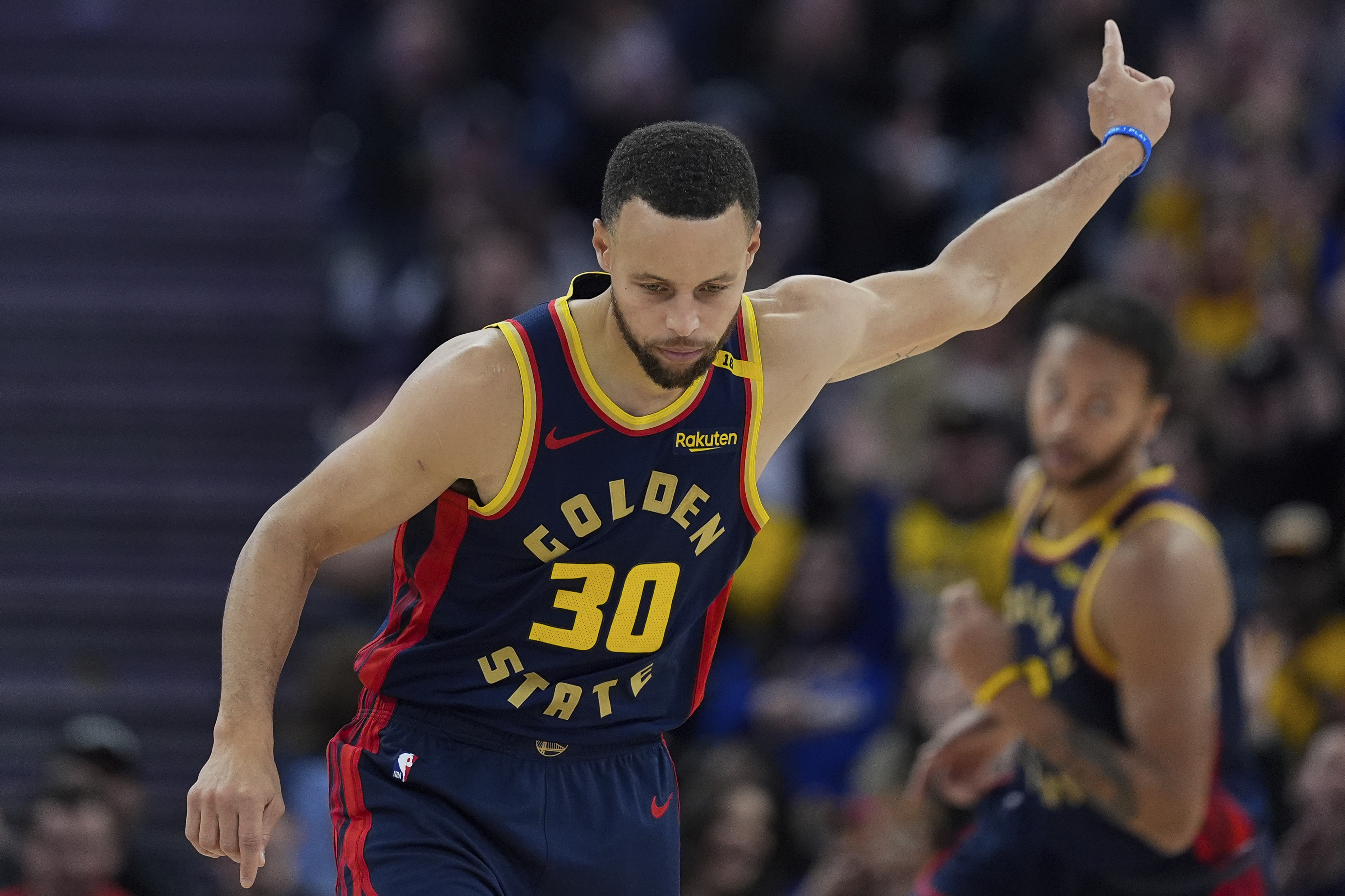 Golden State Warriors guard Stephen Curry reacts after scoring against the Atlanta Hawks during the first half of an NBA basketball game Wednesday, Nov. 20, 2024, in San Francisco.