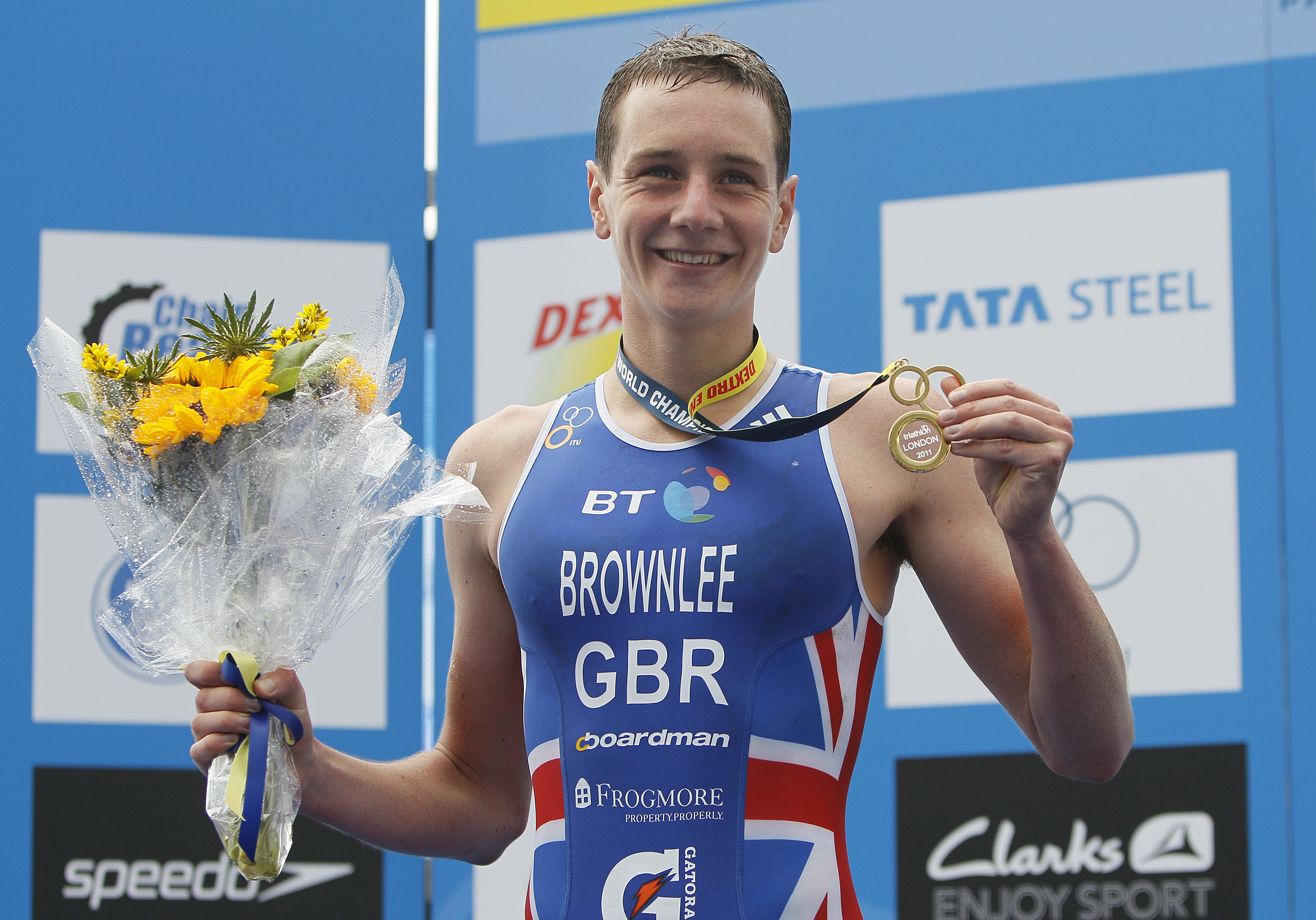 FILE -Britain's Alistair Brownlee, poses for the media with his gold medal for winning the men's ITU World Championship Series Triathlon race in London, Aug., 7, 2011.