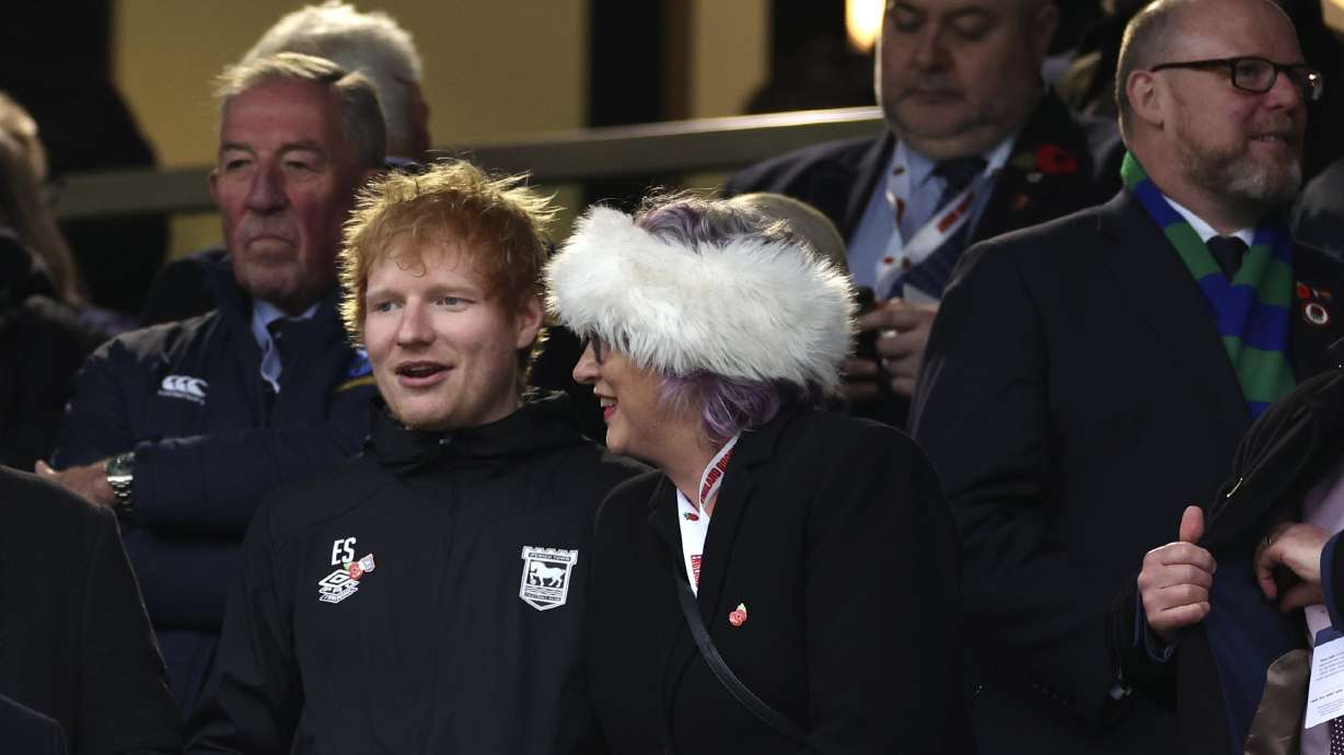 English singer-songwrite Ed Sheeran, left, watches the Autumn Nations series rugby union match between England and Australia, at Twickenham stadium, London Saturday, Nov. 9, 2024.