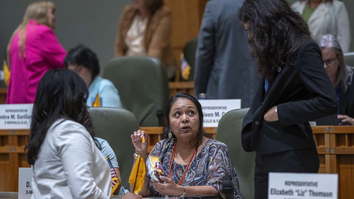 Reena Szczepanski, left, D. Wonda Johnson, center, and Cristina Parajon, talk before the start of a special legislative session in Santa Fe, N.M., on July 18. They are three of the many female state lawmakers nationwide starting next year.
