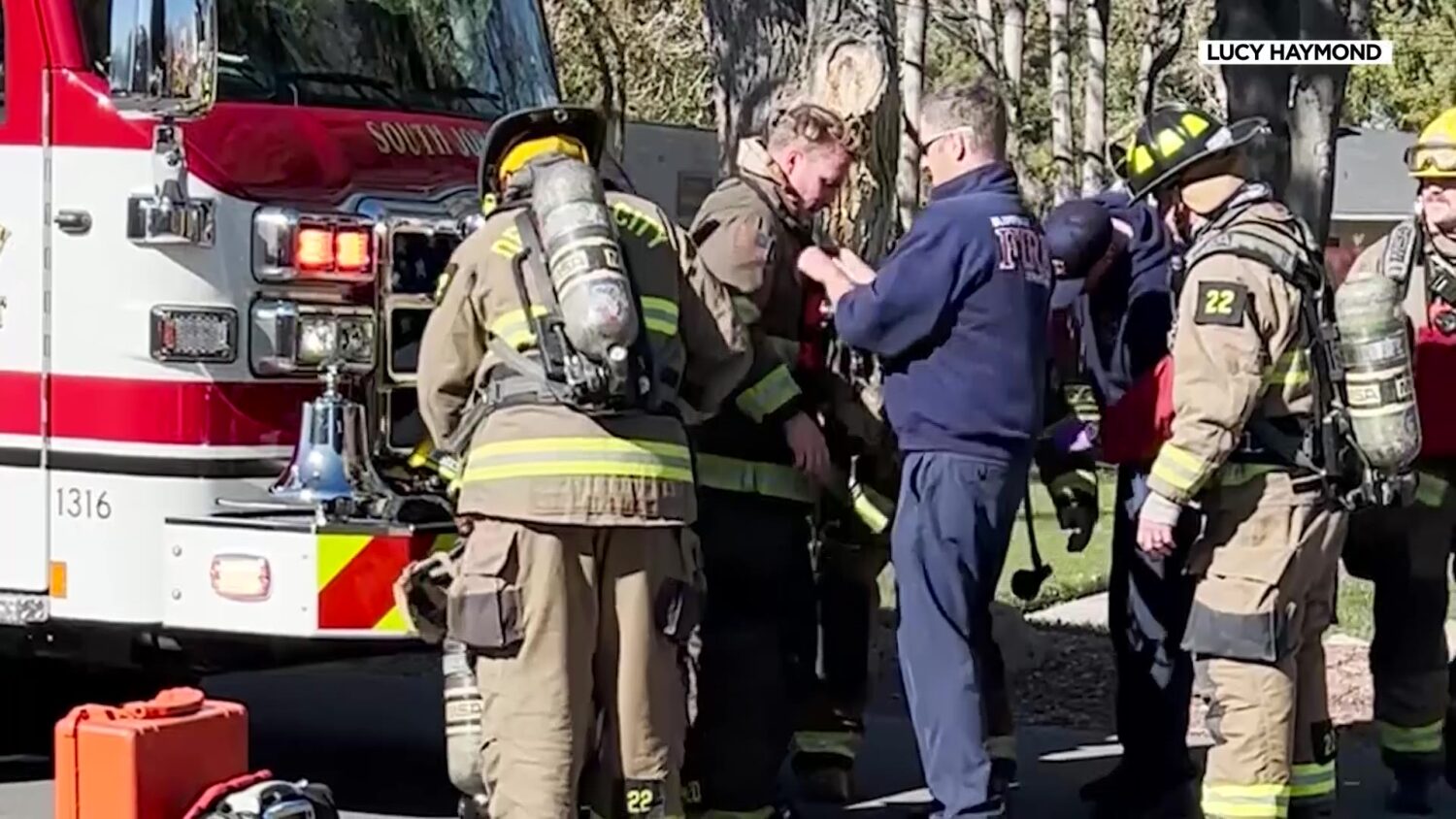 Firefighters Beau Fisher and Alex Thompson are getting checked out by their fellow first responders after catching on fire on Nov. 9 in Riverton.