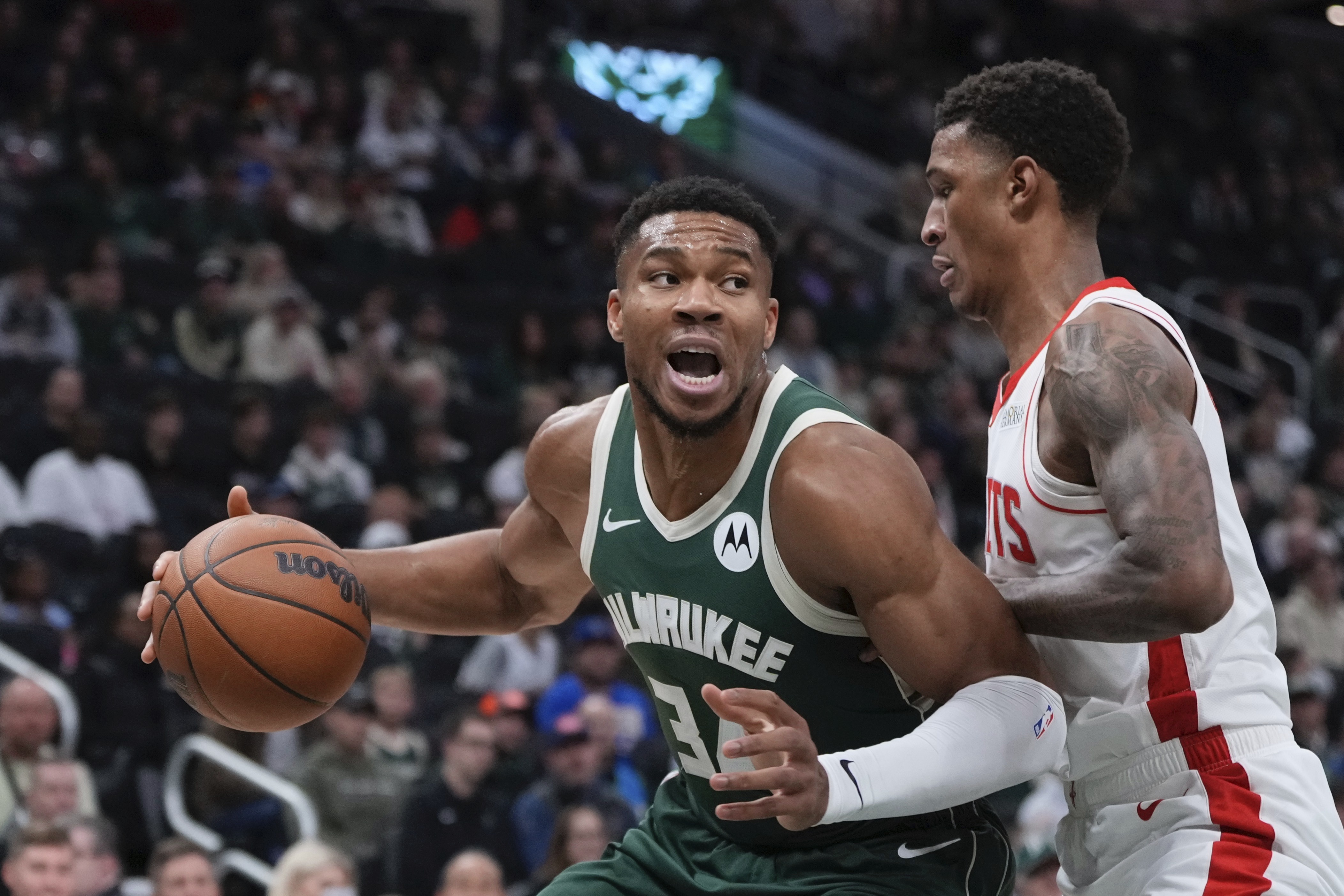 Milwaukee Bucks' Giannis Antetokounmpo tries to get past Houston Rockets' Jabari Smith Jr. during the first half of an NBA basketball game Monday, Nov. 18, 2024, in Milwaukee. 