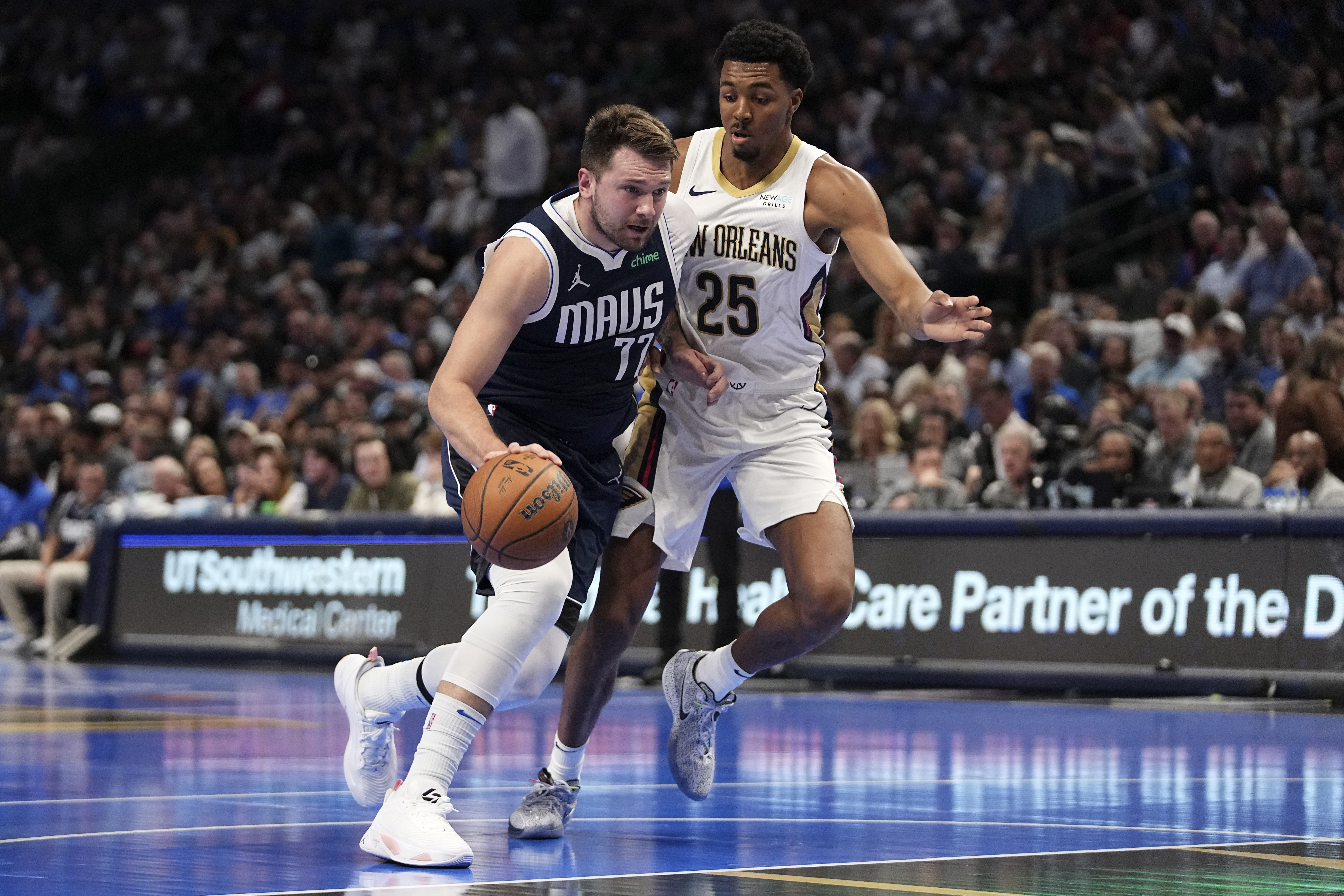 Dallas Mavericks guard Luka Doncic (77) drives to the basket as New Orleans Pelicans' Trey Murphy III (25) defends in the first half of an Emirates NBA Cup basketball game in Dallas, Tuesday, Nov. 19, 2024.