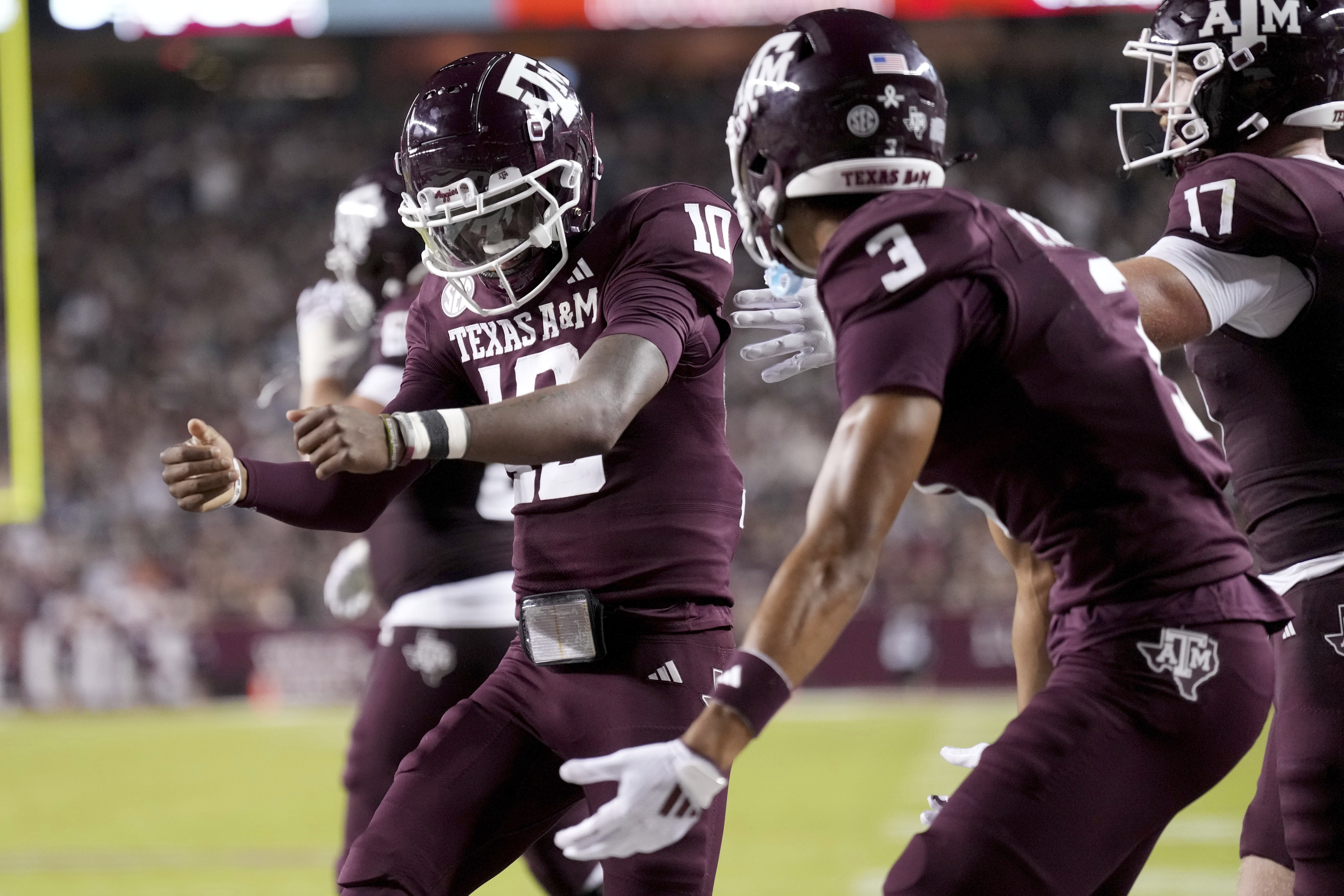 Texas A&M quarterback Marcel Reed (10) reacts near teammate Noah Thomas (3) after scoring a rushing touchdown against New Mexico State during the second half of an NCAA college football game Saturday, Nov. 16, 2024, in College Station, Texas. 