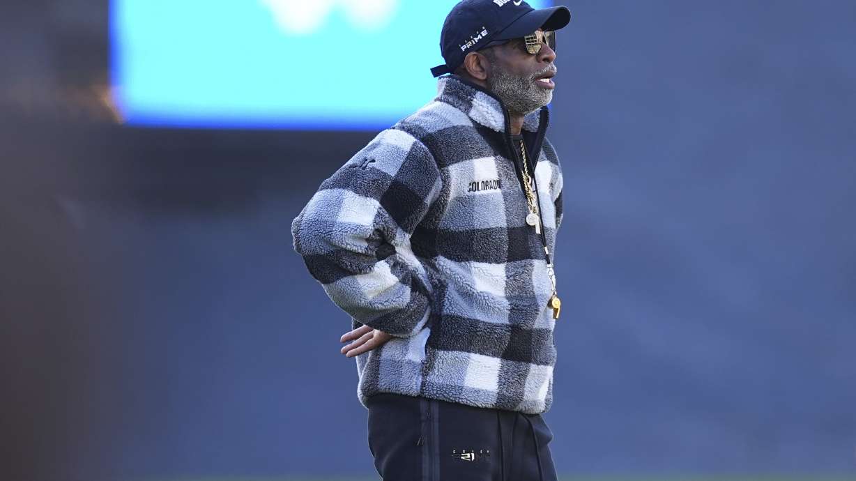 Colorado head coach Deion Sanders looks on as players warm up before an NCAA college football game against Utah Saturday, Nov. 16, 2024, in Boulder, Colo.