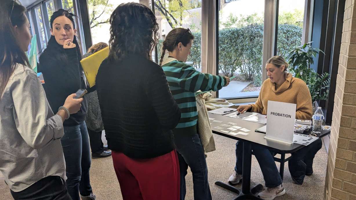 Participants in a simulation Thursday wait to meet with a "probation officer" in Salt Lake City. The simulation was organized with the hopes of demonstrating the difficulty of reentering society after homelessness and/or incarceration.