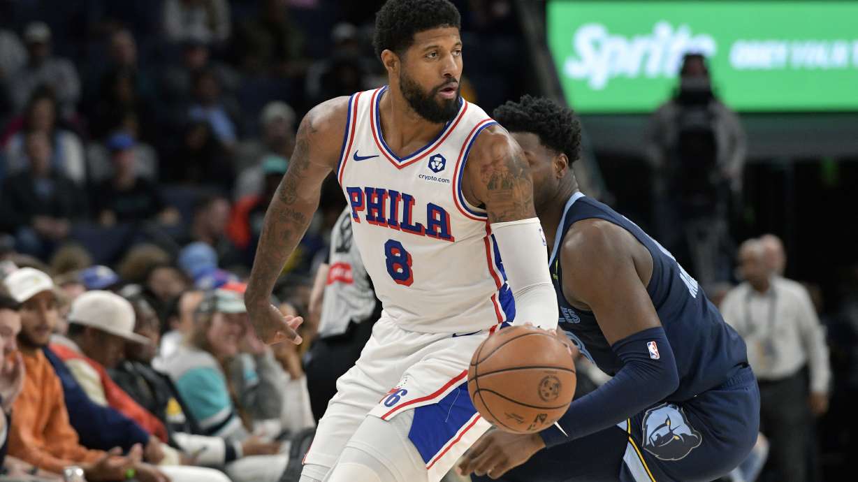 Philadelphia 76ers forward Paul George (8) handles the ball ahead of Memphis Grizzlies forward Jaren Jackson Jr. (13) in the first half of an NBA basketball game Wednesday, Nov. 20, 2024, in Memphis, Tenn.
