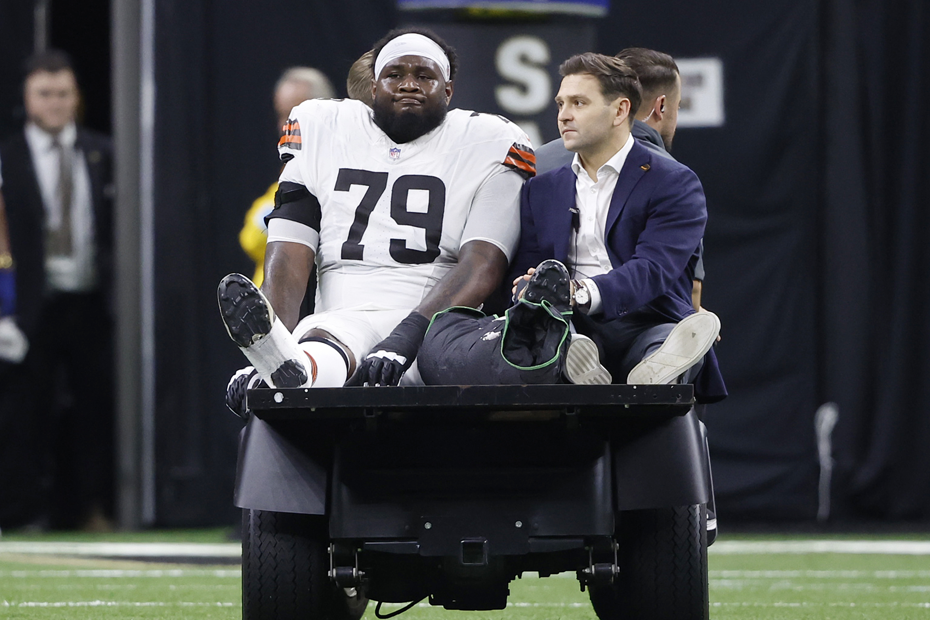 Cleveland Browns offensive tackle Dawand Jones (79) is carted off the field after an injury in the first half of an NFL football game against the New Orleans Saints in New Orleans, Sunday, Nov. 17, 2024.