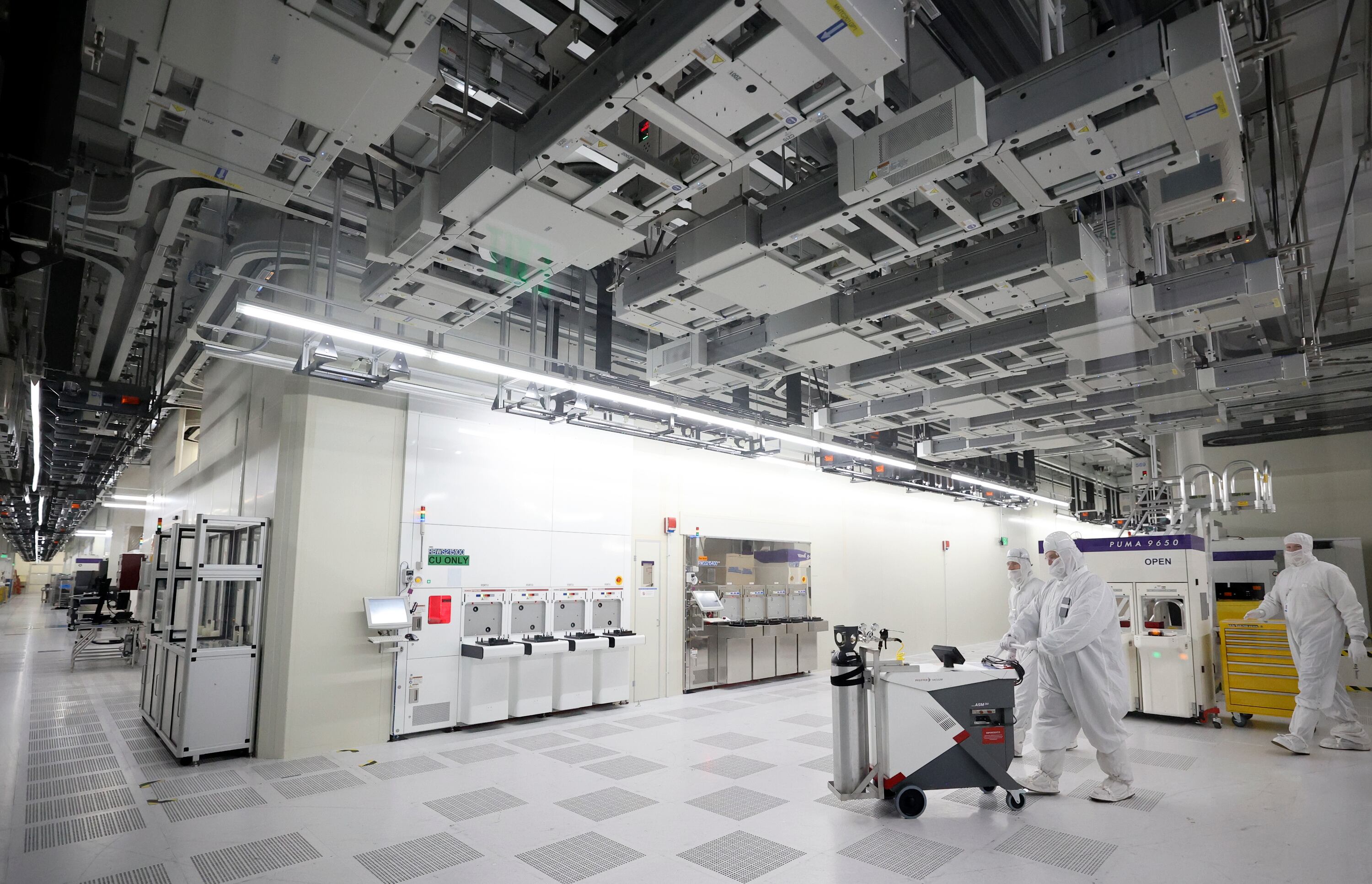 Manufacturing technicians in a cleanroom supporting semiconductor wafer fabrication at Texas Instruments in Lehi on Nov. 2, 2023. The White House wrapping up deals with chipmakers during the final period of President Joe Biden's time in office.