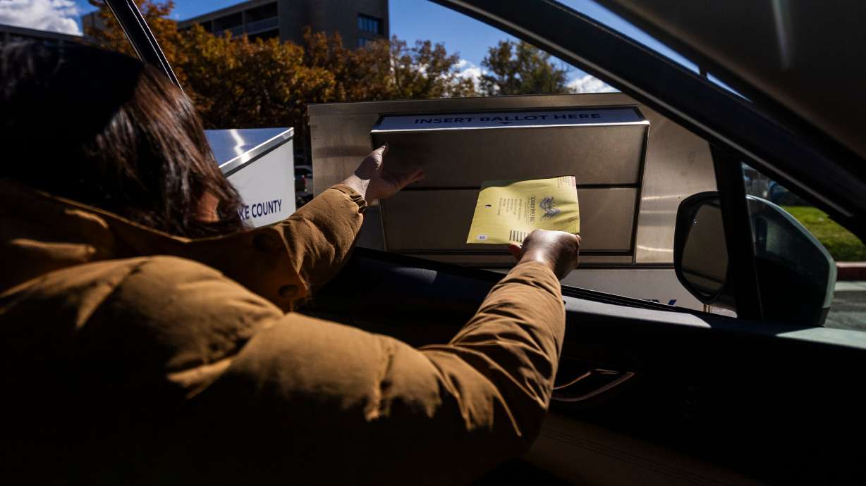 Amanda Stewart, from Salt Lake City, drops off her and her husband’s ballots outside of the Salt Lake County Government Center in Salt Lake City on Nov. 4.