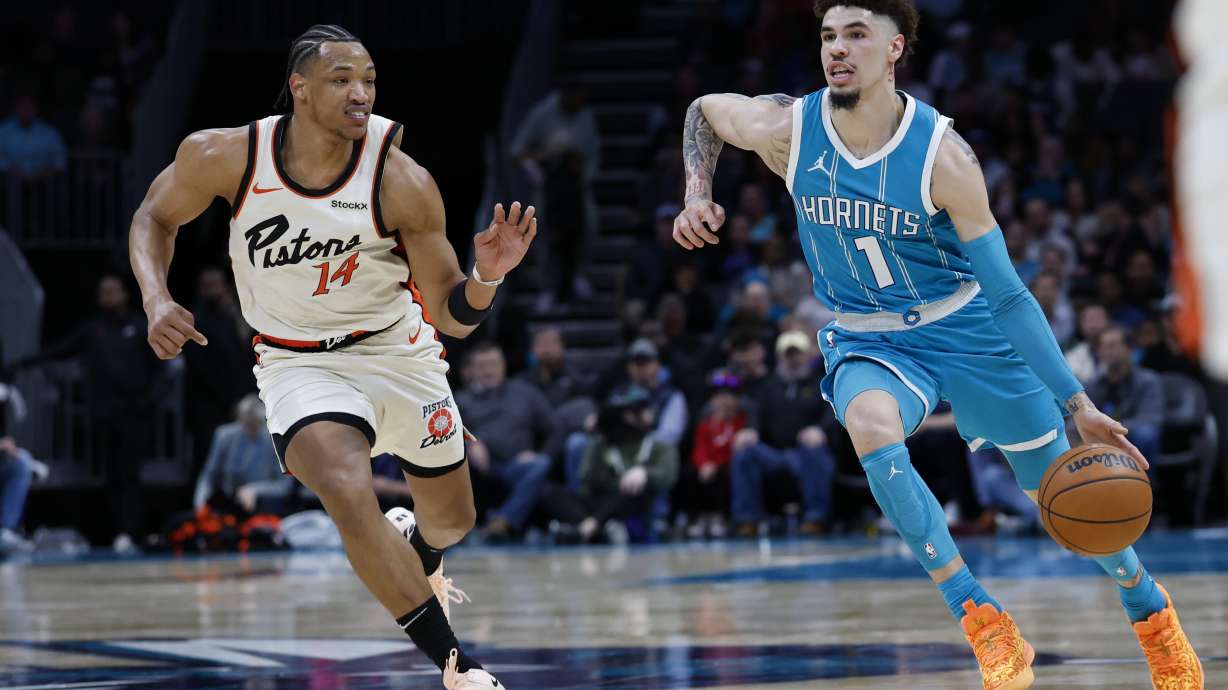 Charlotte Hornets guard LaMelo Ball (1) drives to the basket past Detroit Pistons guard Wendell Moore Jr.,left, during the first half of an NBA basketball game in Charlotte, N.C., Thursday, Nov. 21, 2024.