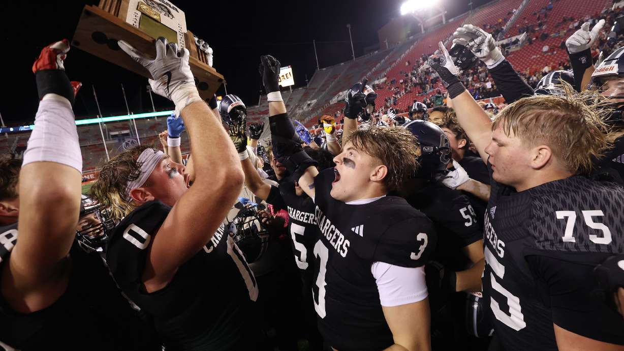 Corner Canyon celebrates a win over Lone Peak in the 6A state championship at Rice-Eccles stadium in Salt Lake City on Thursday, Nov. 21, 2024.