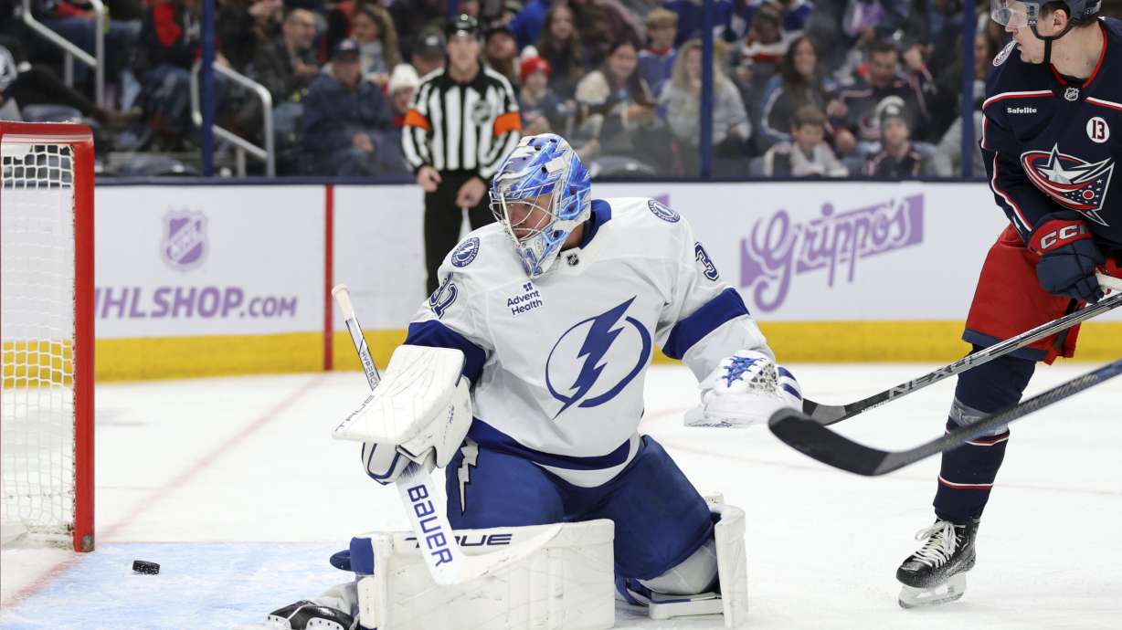 Columbus Blue Jackets forward Dmitri Voronkov, right, watches a goal by teammate Zach Werenski (not shown) get past Tampa Bay Lightning goalie Jonas Johansson, left, during the second period of an NHL hockey game in Columbus, Ohio, Thursday, Nov. 21, 2024.