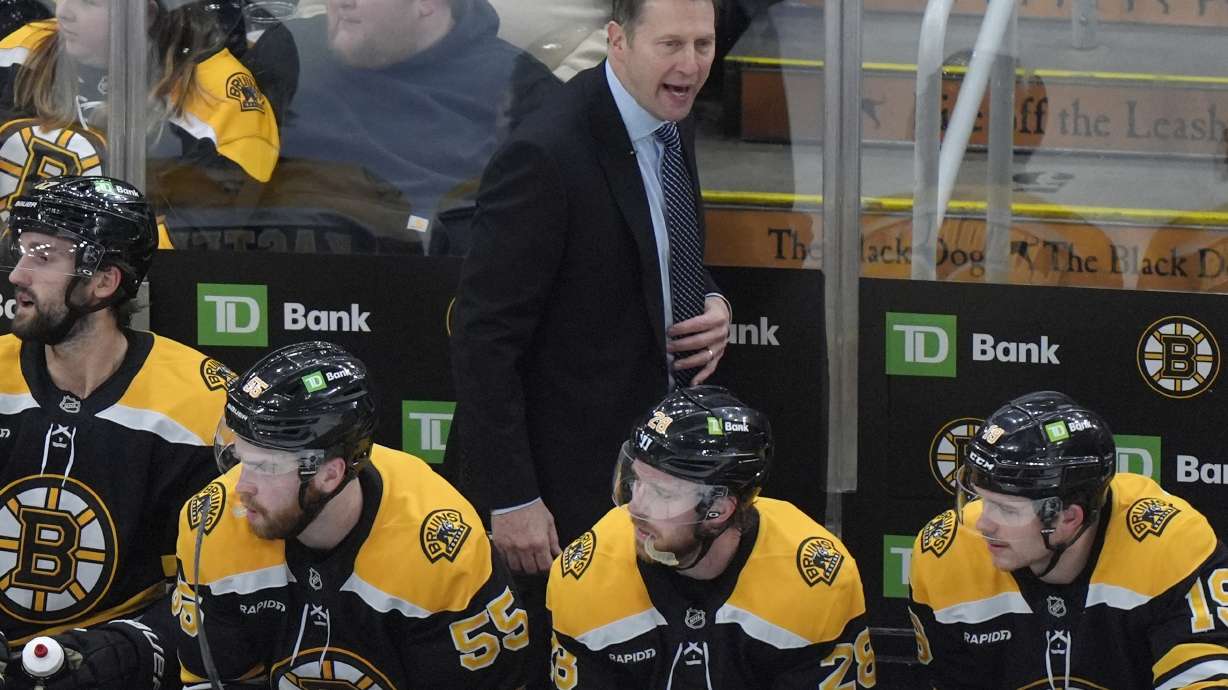 Boston Bruins interim head coach Joe Sacco, center top, shouts to his players in the second period of an NHL hockey game against the Utah Hockey Club, Thursday, Nov. 21, 2024, in Boston.