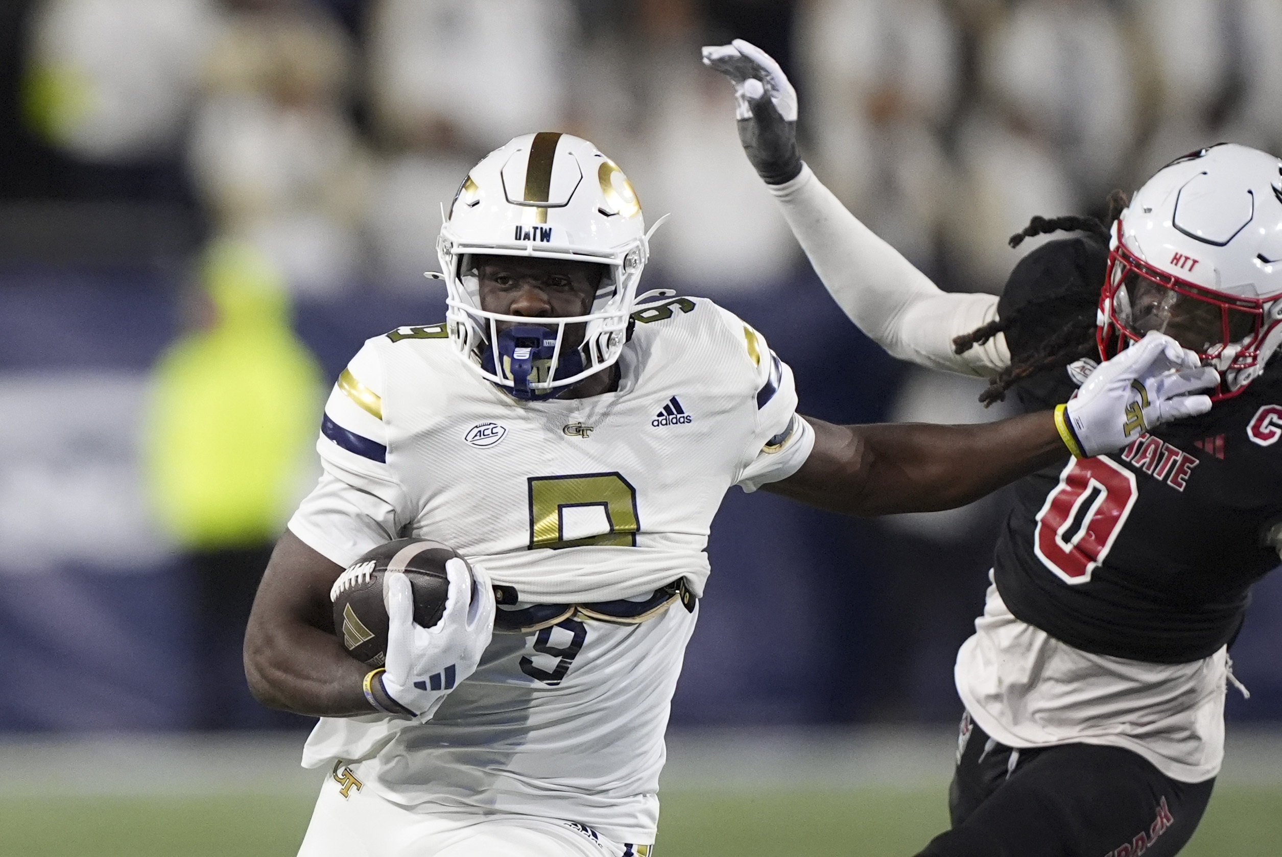 Georgia Tech wide receiver Avery Boyd (9) runs the ball against North Carolina State linebacker Sean Brown (0) during the first half of an NCAA college football game, Thursday, Nov. 21, 2024, in Atlanta.