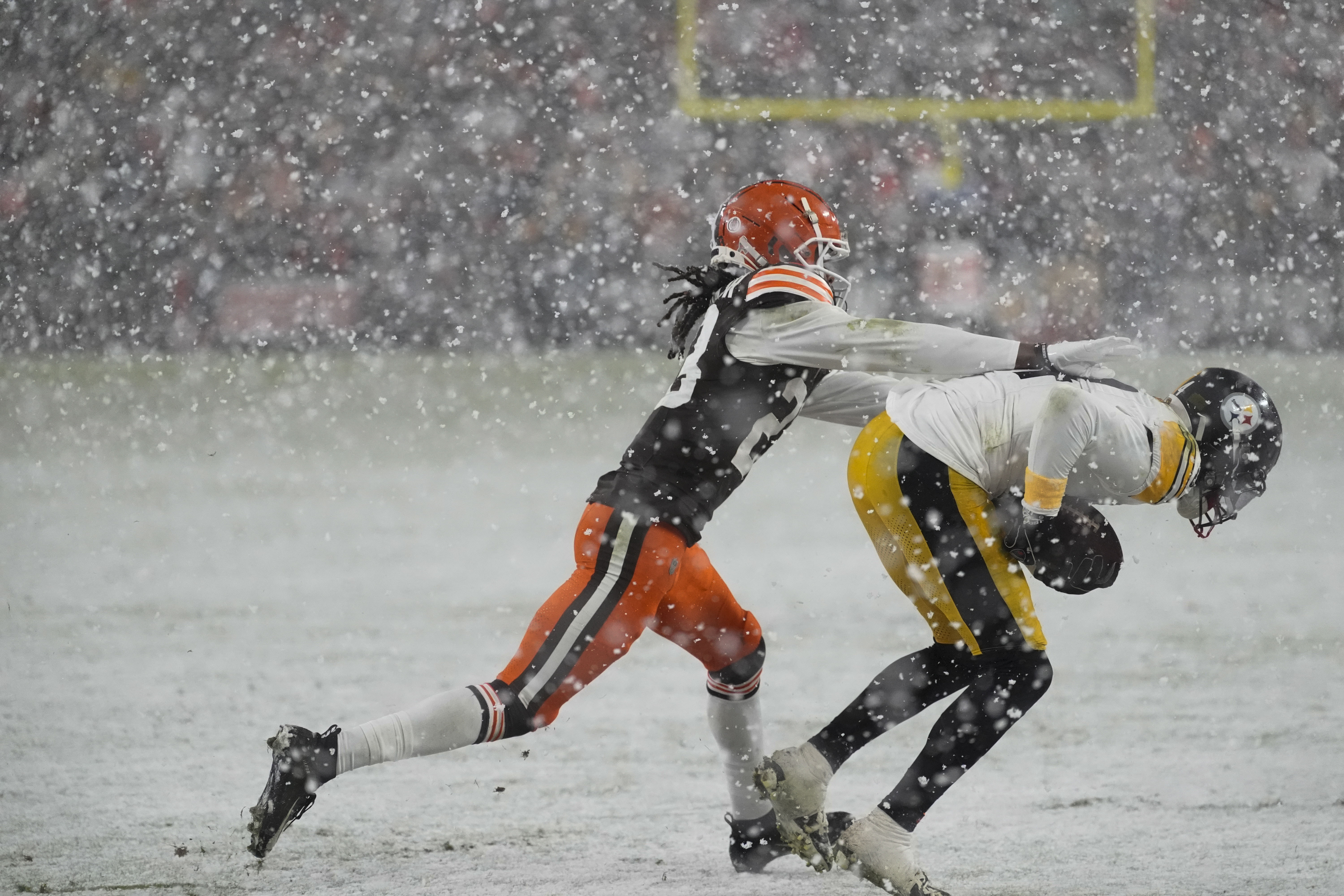 Cleveland Browns cornerback Cameron Mitchell pushes Pittsburgh Steelers wide receiver George Pickens out of bounds in the second half of an NFL football game, Thursday, Nov. 21, 2024, in Cleveland.