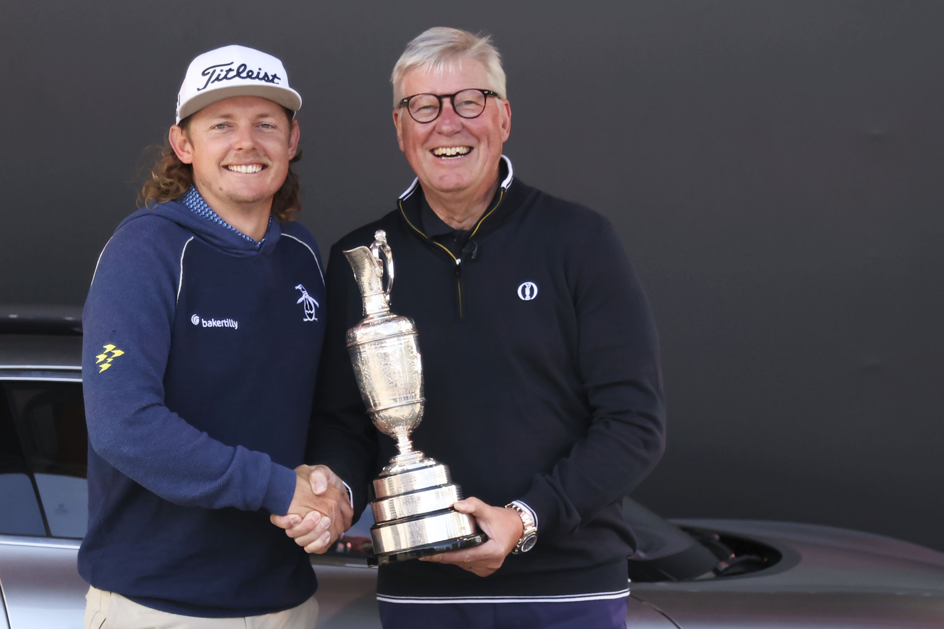 FILE - Martin Slumbers, the Chief Executive of The R&A and Secretary of The Royal and Ancient Golf Club St Andrews, with the Claret Jug trophy, and Australia's Cameron Smith, winner of the 2022 British Open, shake hands at the Royal Liverpool Golf Club in Hoylake, England, on July 17, 2023.